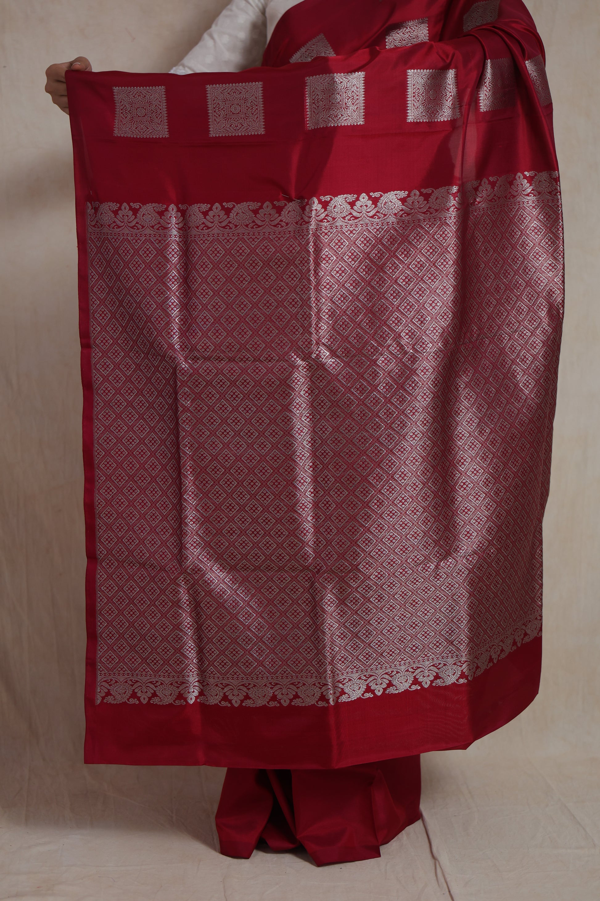 Detailed view of the saree body featuring elegant silver woven buttas on luxurious Venkatgiri silk.
