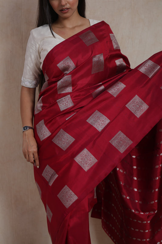 Close-up of the richly woven pallu and border of the crimson red Venkatgiri silk saree.