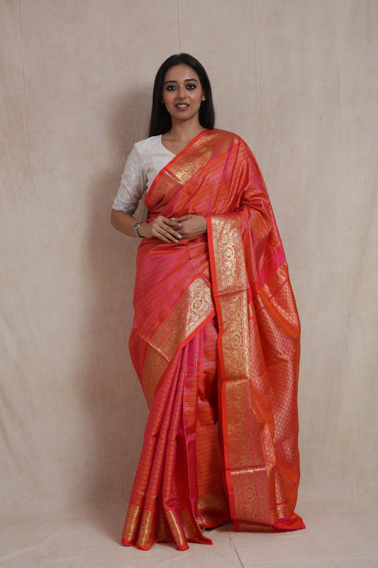Front view of Coral Orange Kanjivaram Silk  Saree with woven border and elegant drape