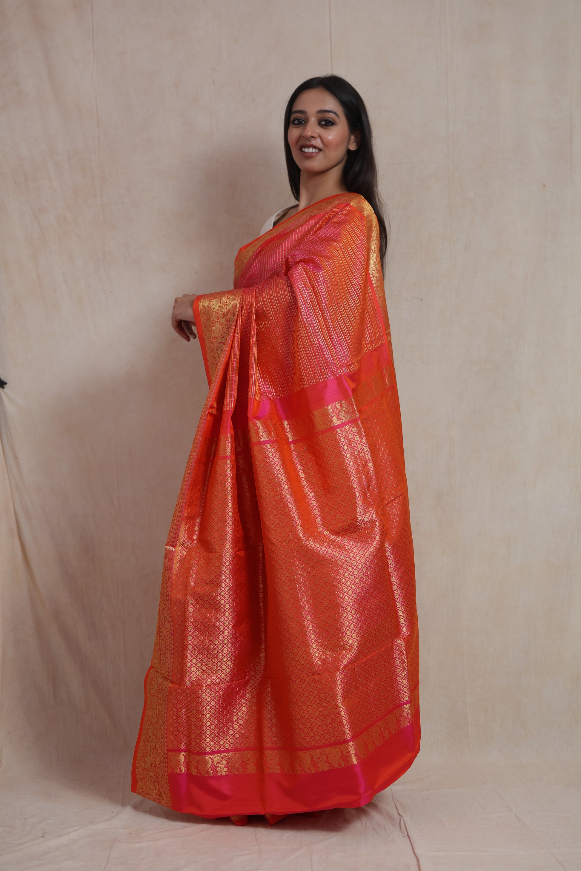 Side view of Coral Orange Kanjivaram Silk  Saree showcasing the richly woven pallu