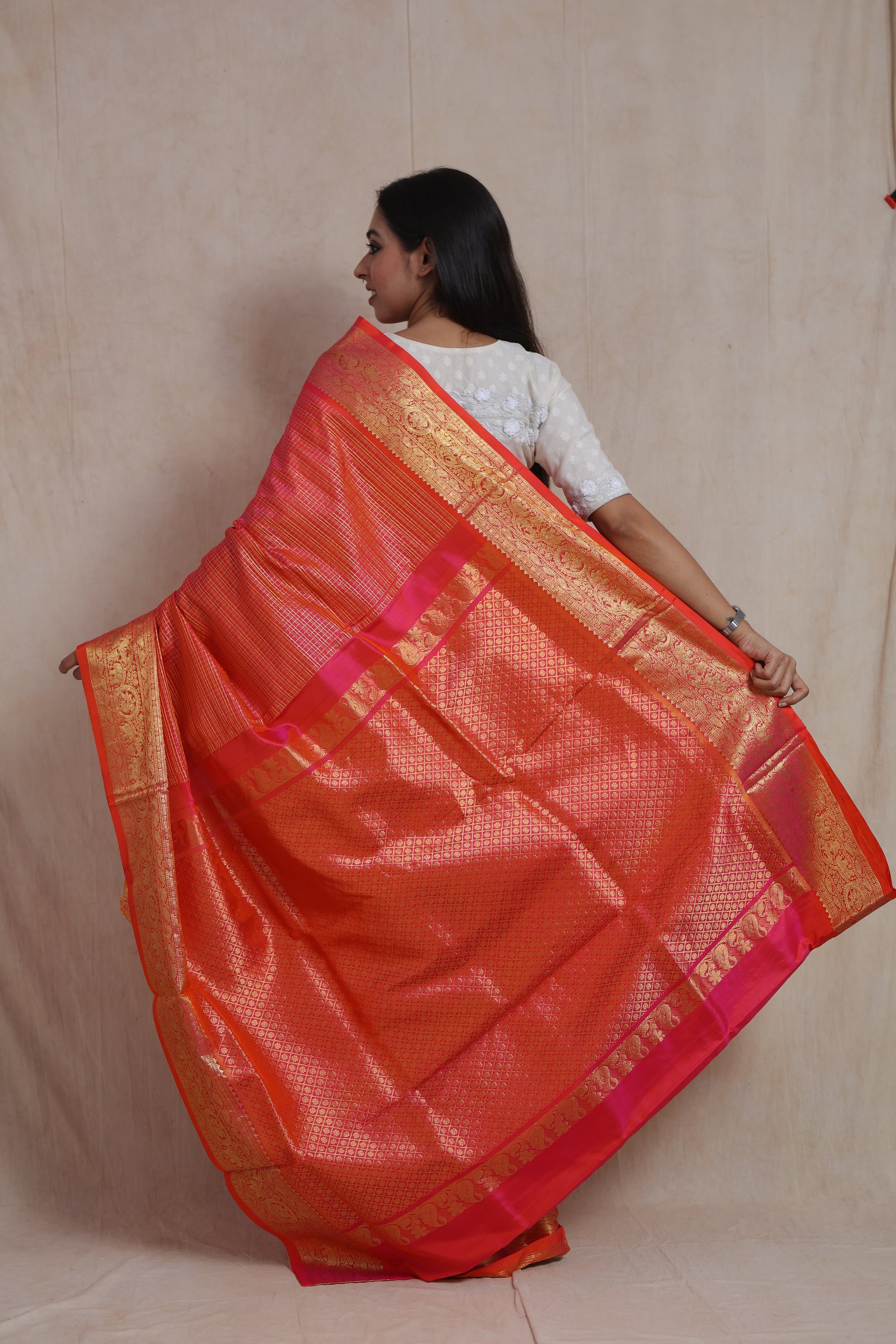 Back view of Coral Orange Kanjivaram Silk  Saree highlighting the intricate woven pallu