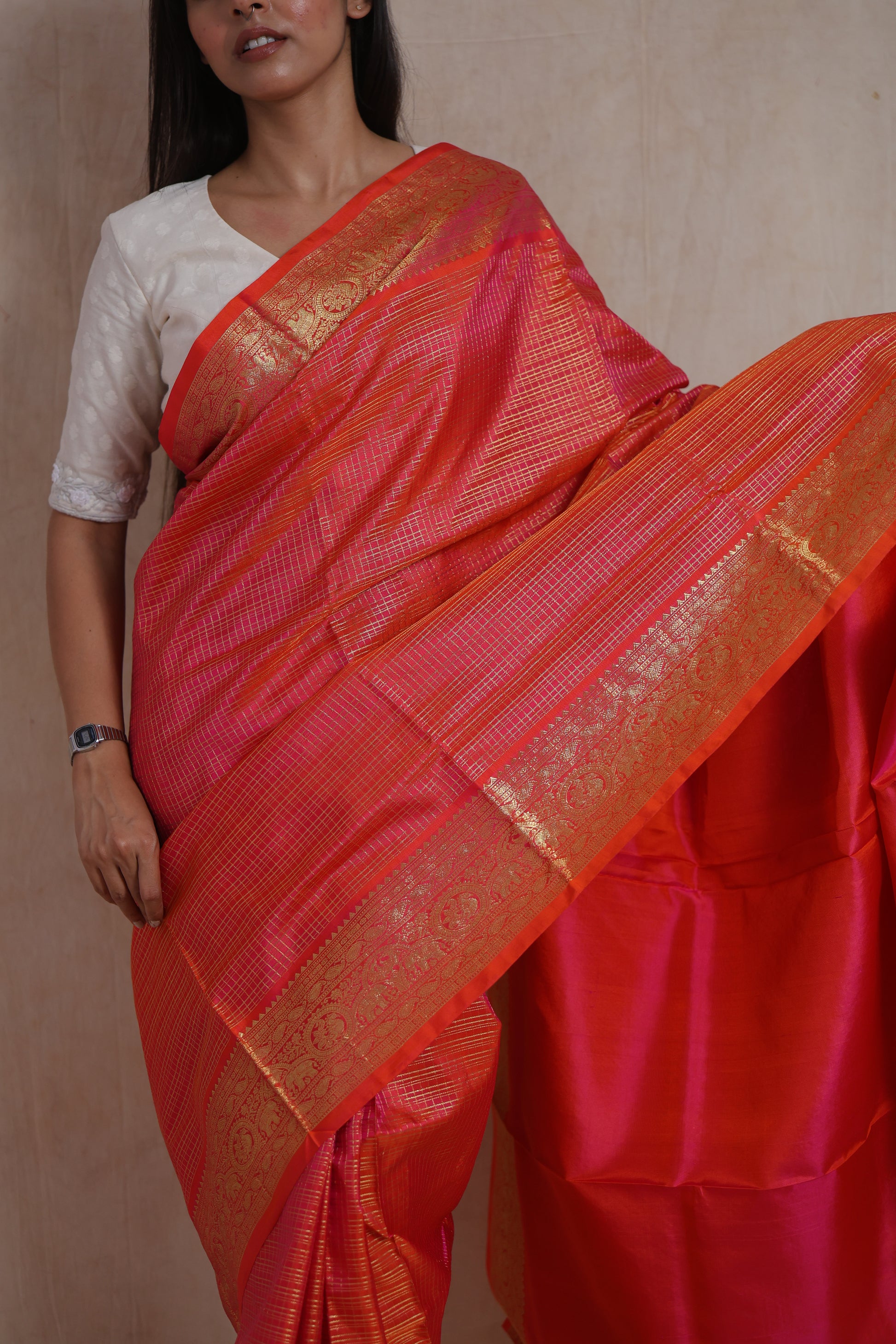 Close-up of the woven border and body of the Coral Orange Kanjivaram Silk  Saree