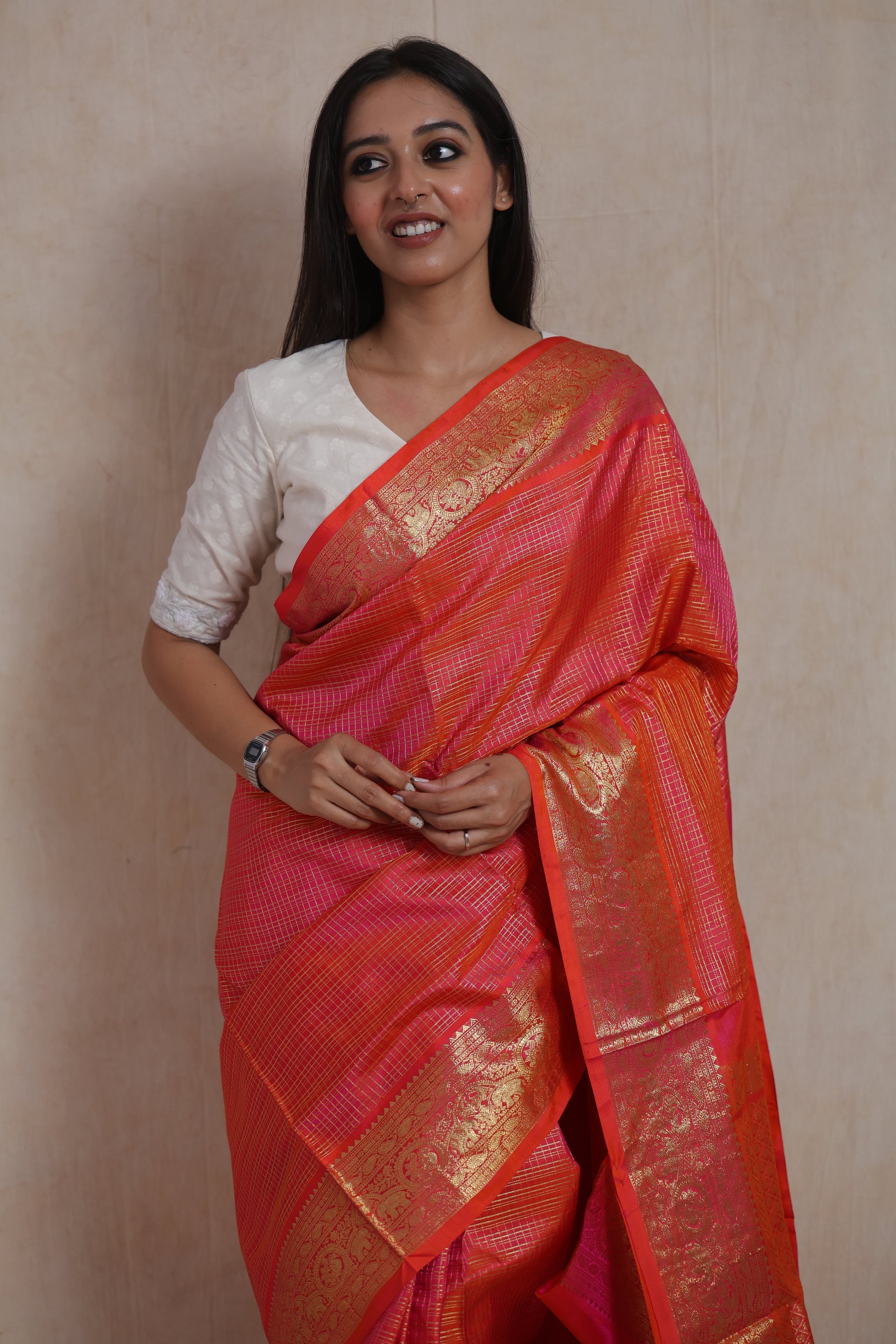 Close-up of the woven border and body of the Coral Orange Kanjivaram Silk  Saree
