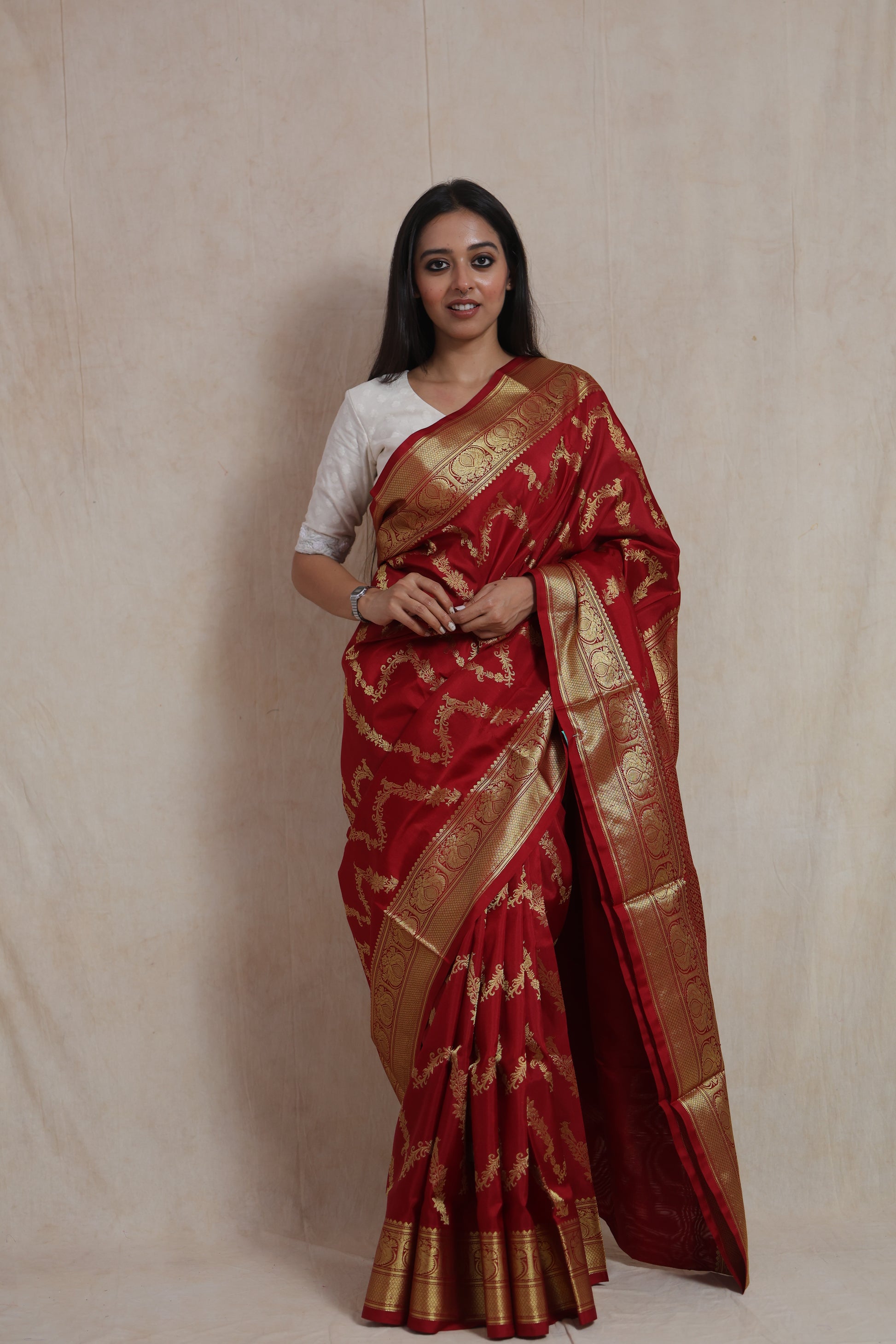 Front view of royal crimson Venkatgiri silk saree with woven floral motifs and broad traditional border