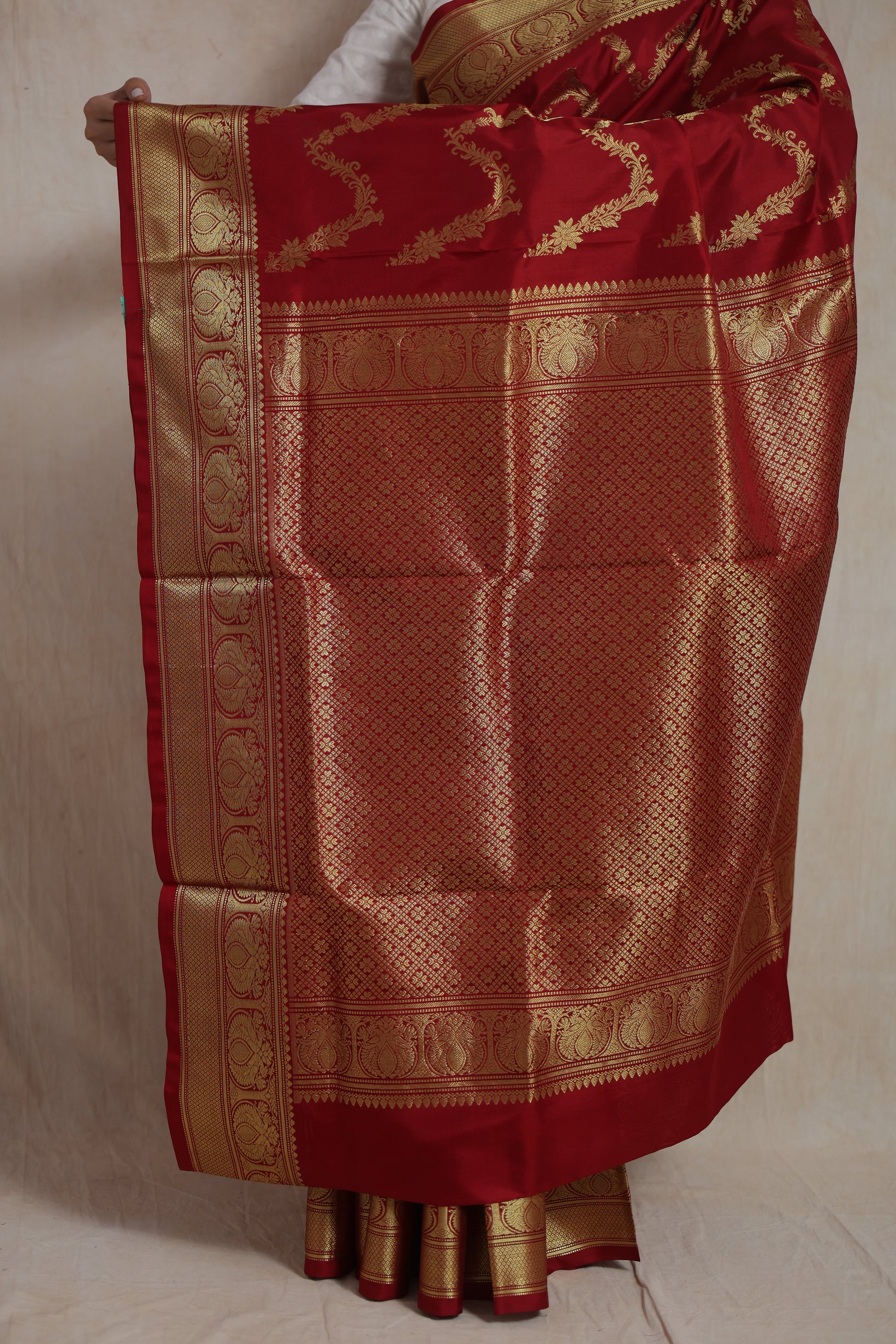 Detailed view of the richly woven pallu and traditional border of the crimson Venkatgiri silk saree