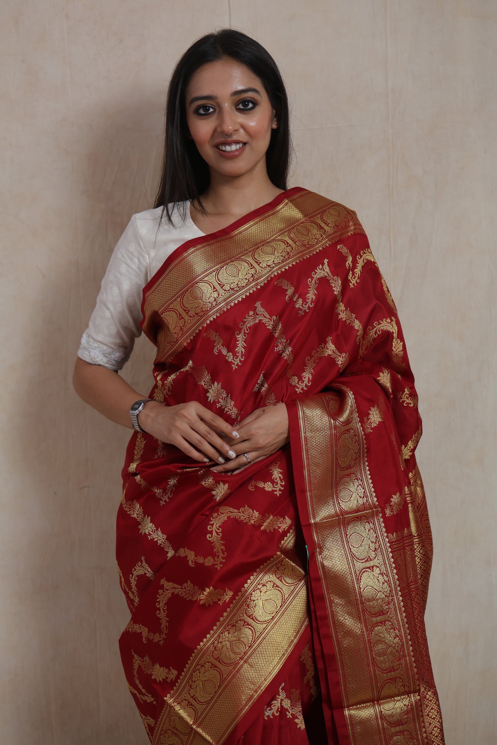 Close-up of the woven floral motifs and traditional border on the crimson Venkatgiri silk saree