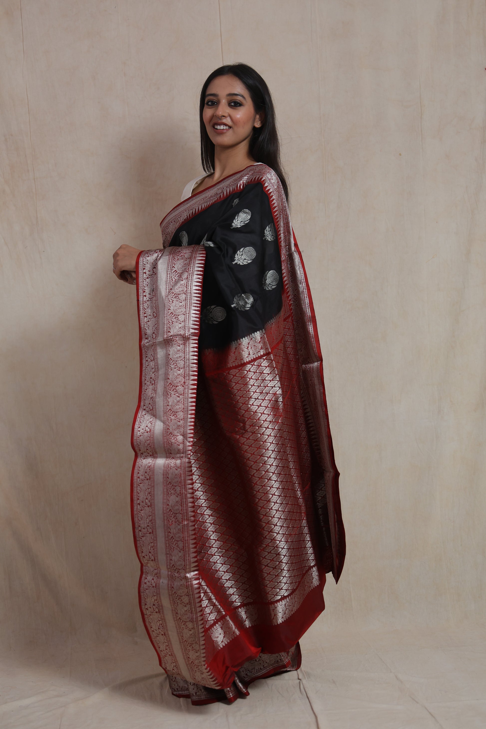 Side view of the black Kanjivaram silk saree showcasing its elegant silver border and luxurious pallu.