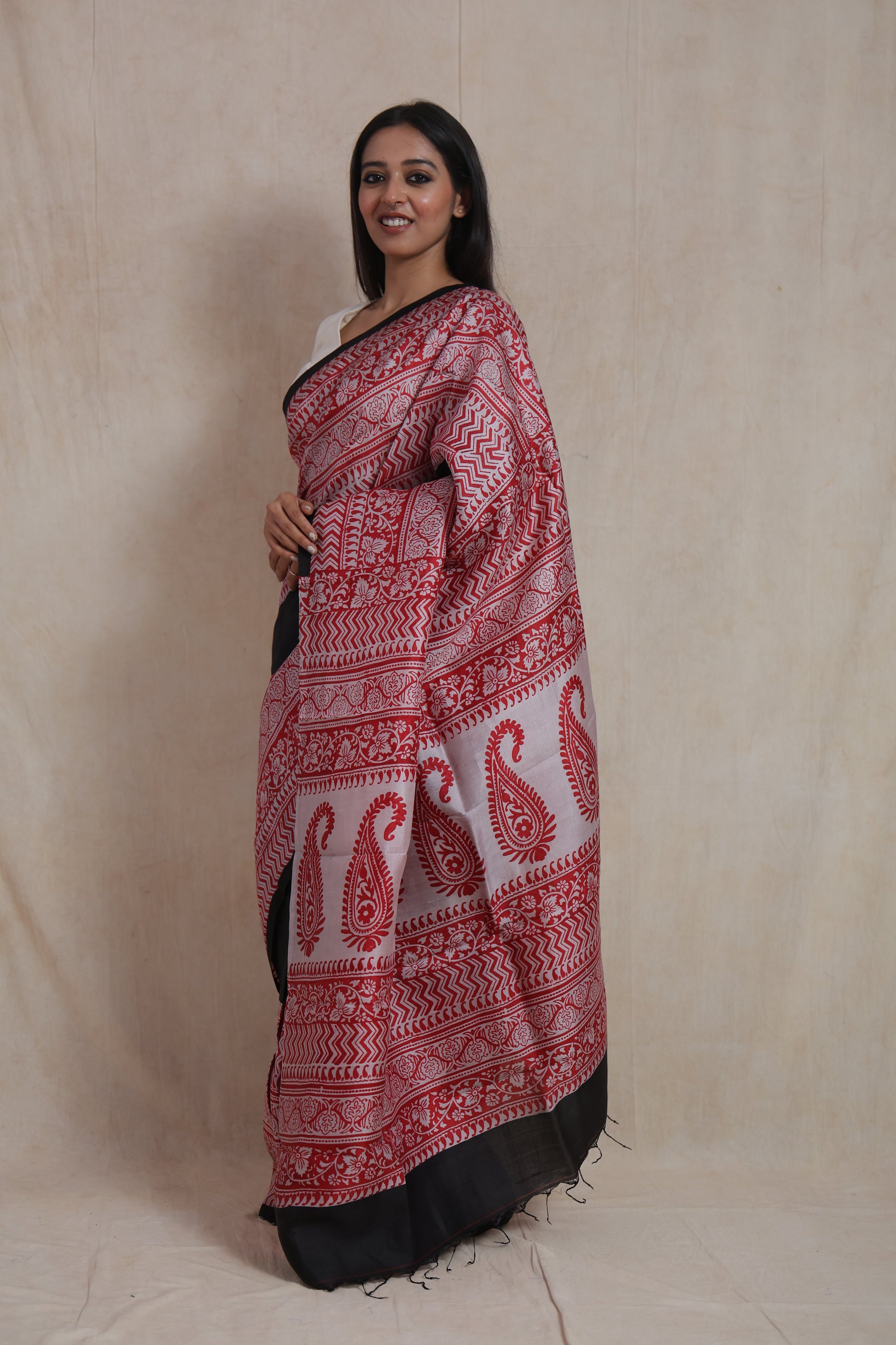 Side profile of handcrafted black Batik silk saree with traditional red motifs