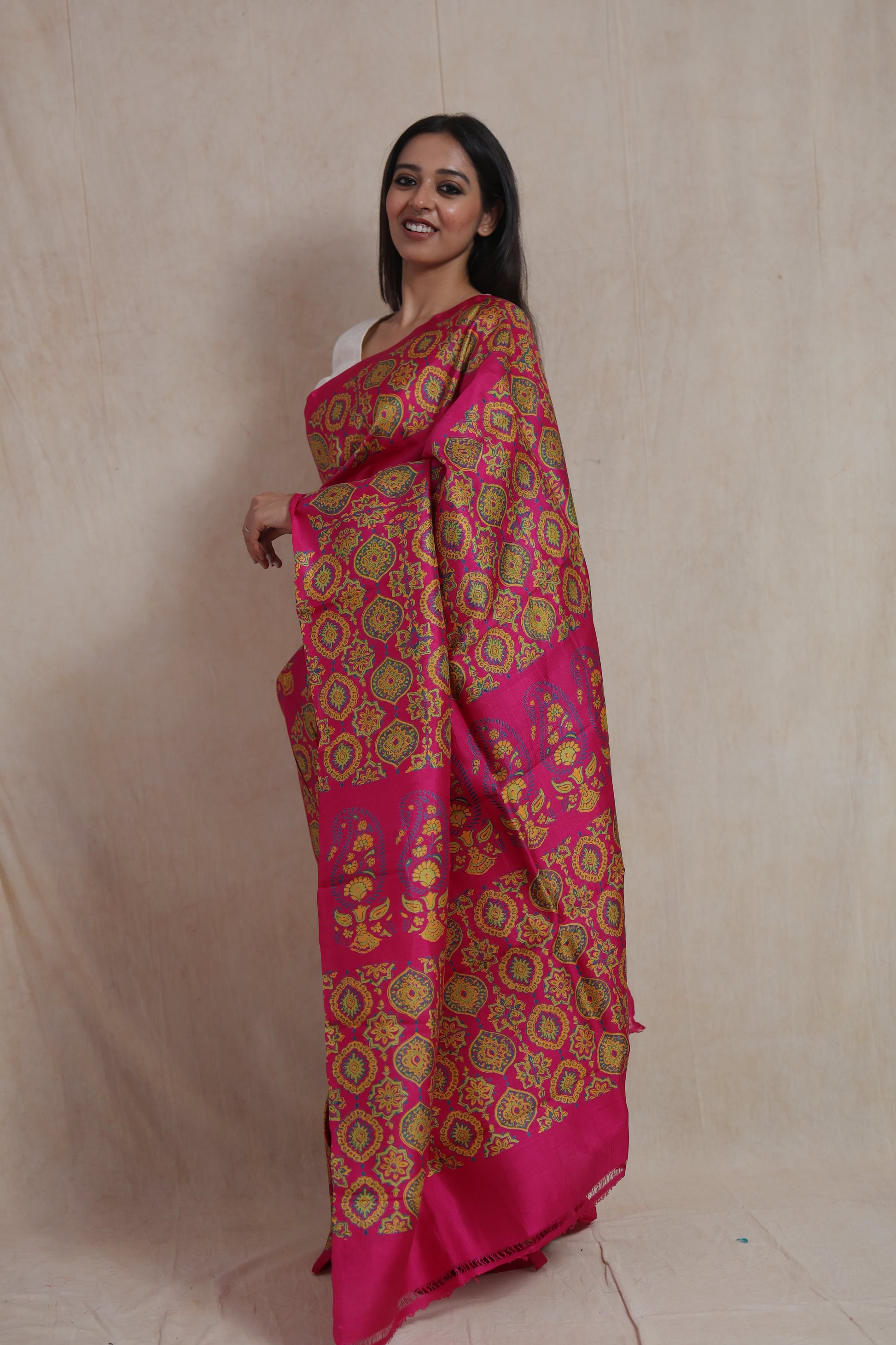 Side profile of rani pink Batik silk saree with artistic floral motif detailing