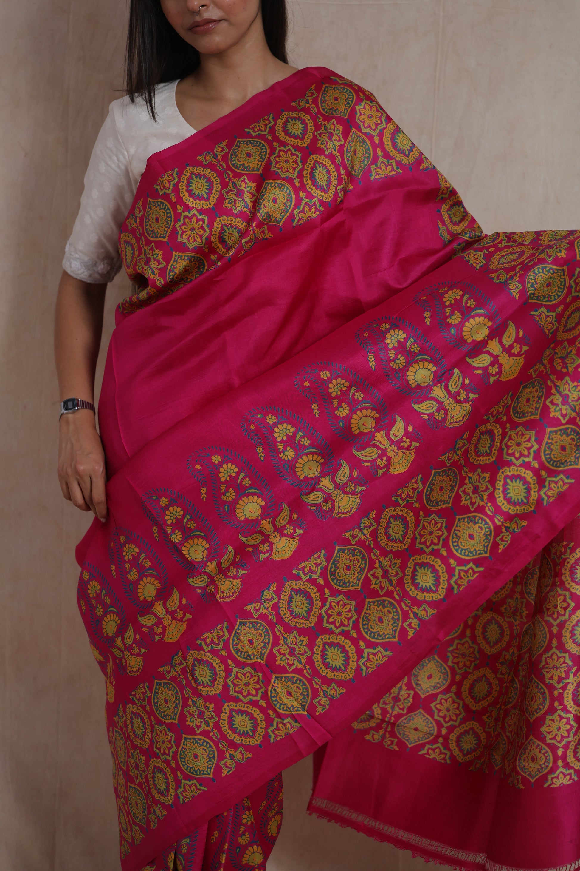 Detailed close-up of floral medallion and paisley Batik artwork on pink silk saree