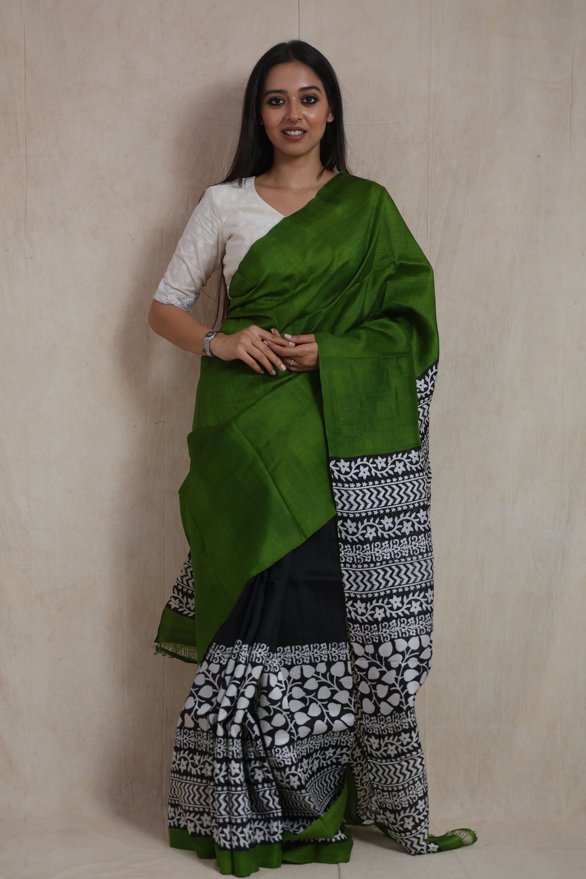 Full front view of emerald green Garad handloom silk saree with contrasting black and white pallu