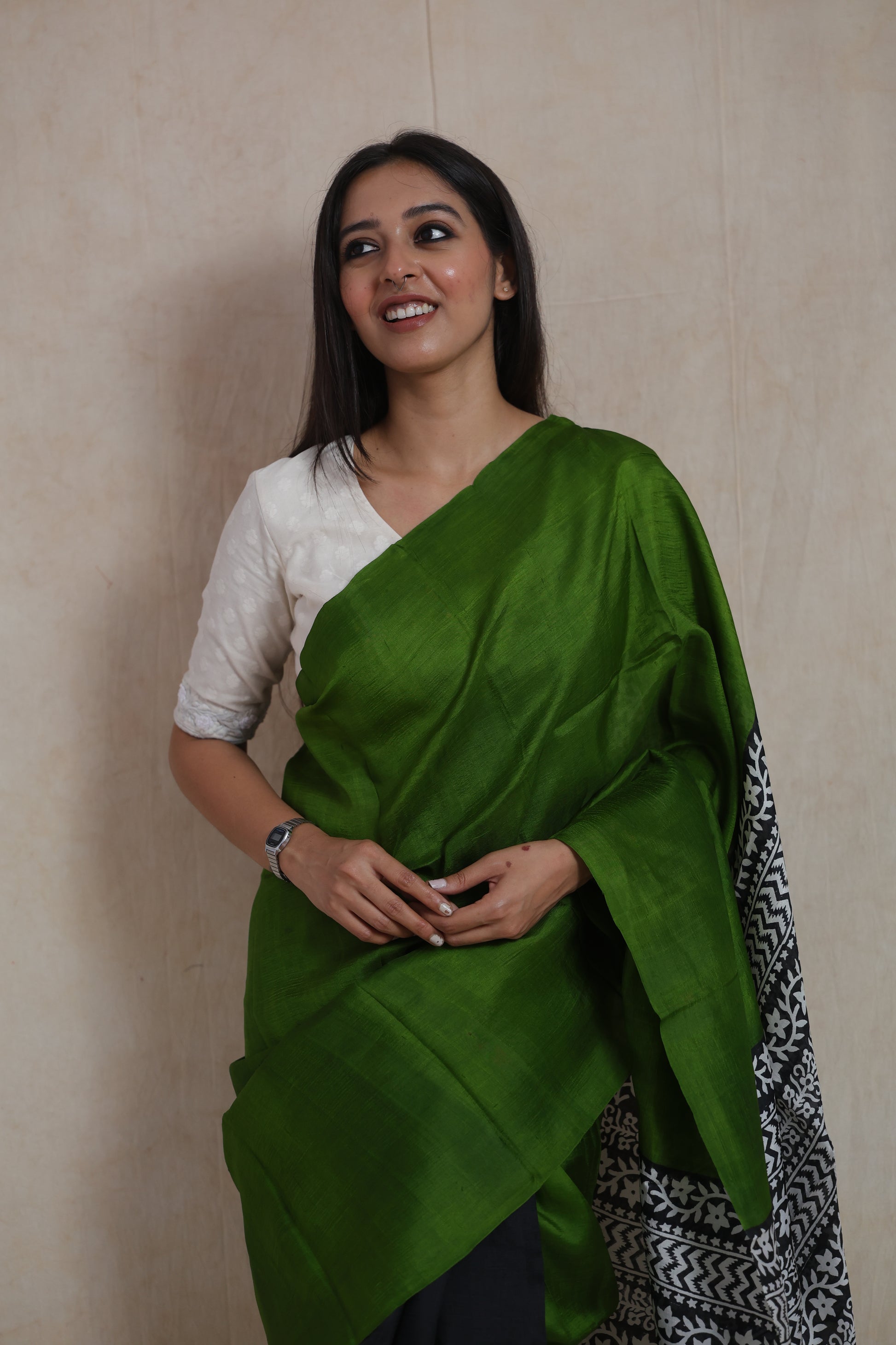 Model draped in emerald green Garad handloom silk saree with elegant traditional styling