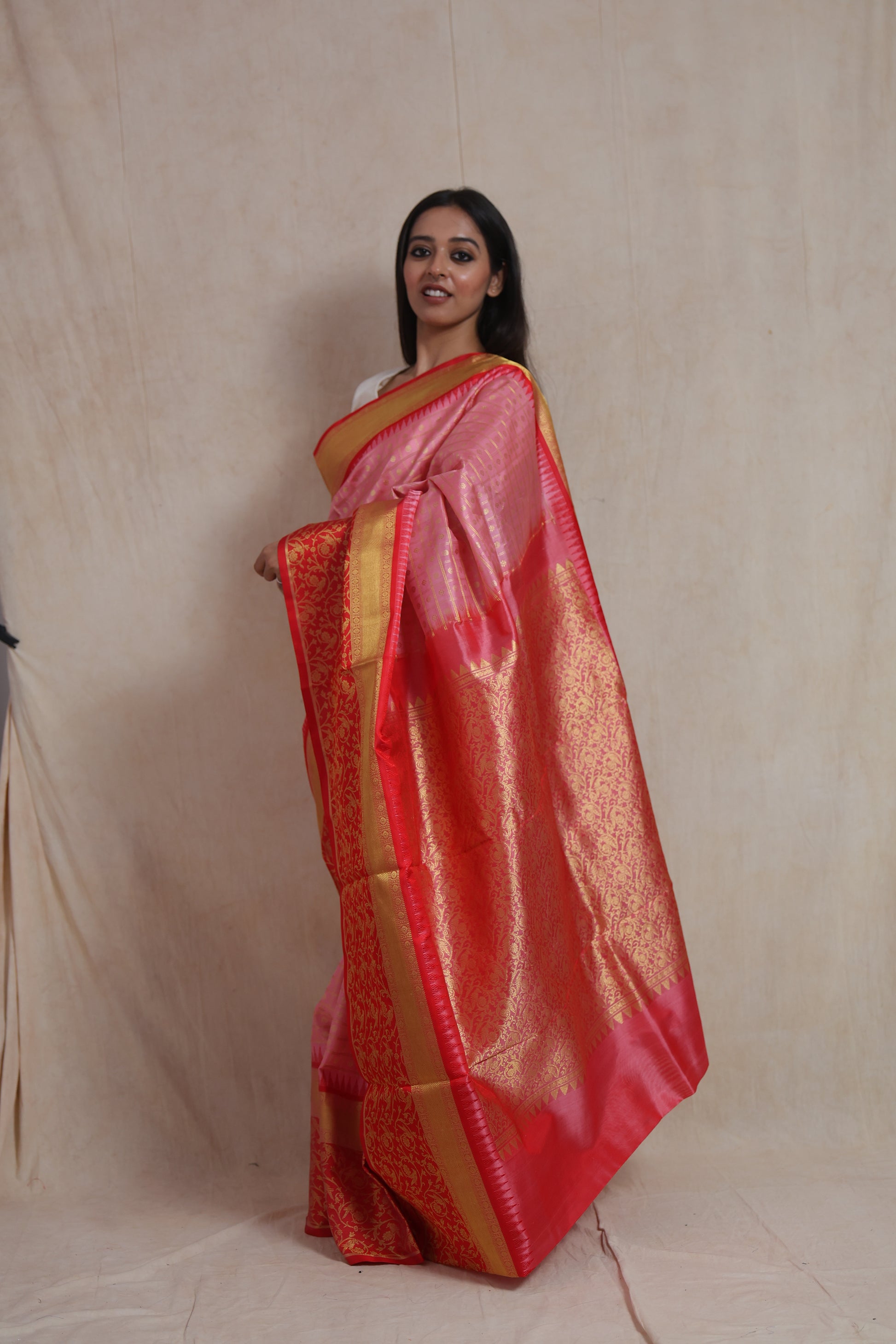Side view of the blush pink Venkatgiri silk saree highlighting its luxurious drape and ornate woven pallu.