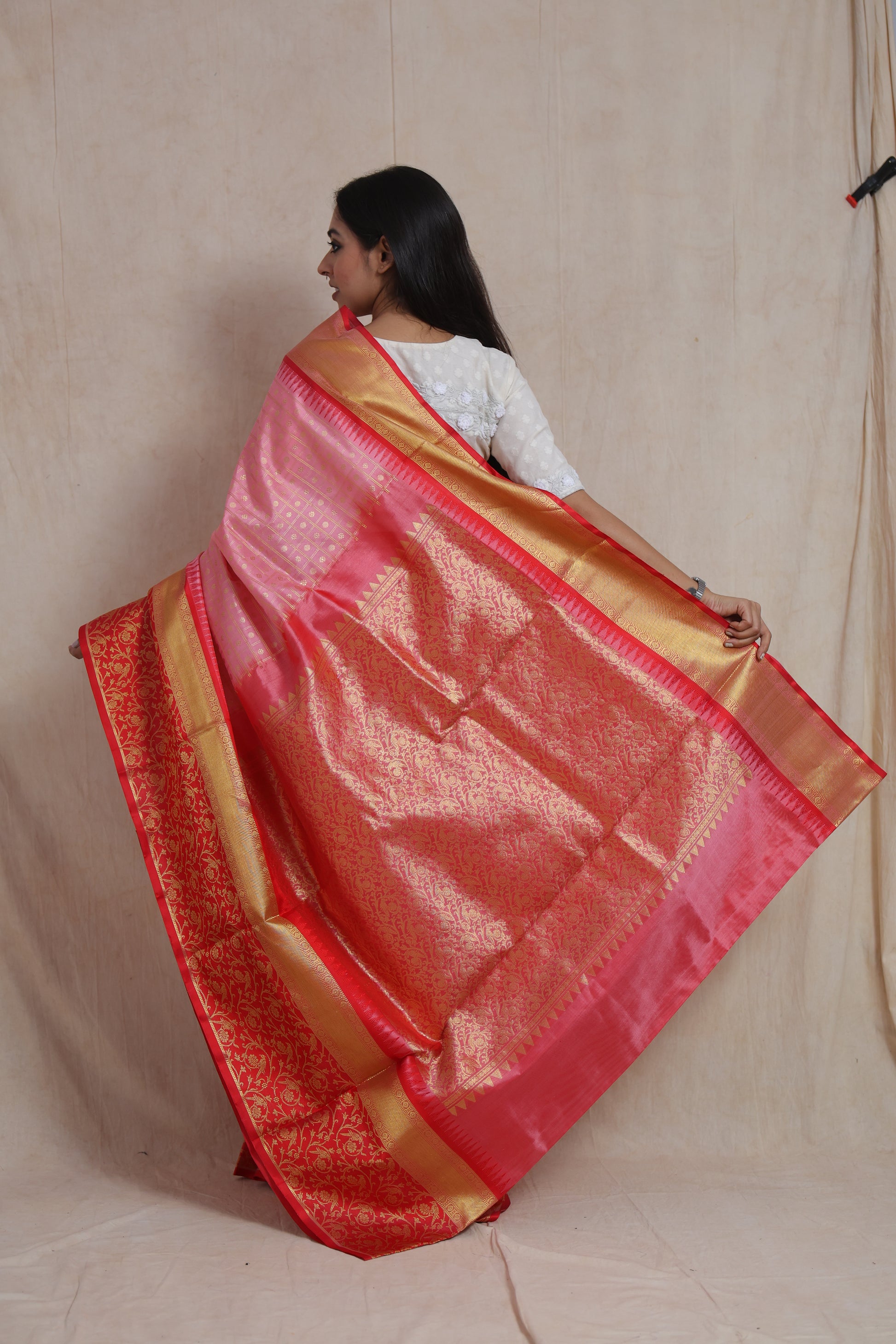 Back view of the Venkatgiri silk saree showcasing the intricately woven red floral pallu and golden border.