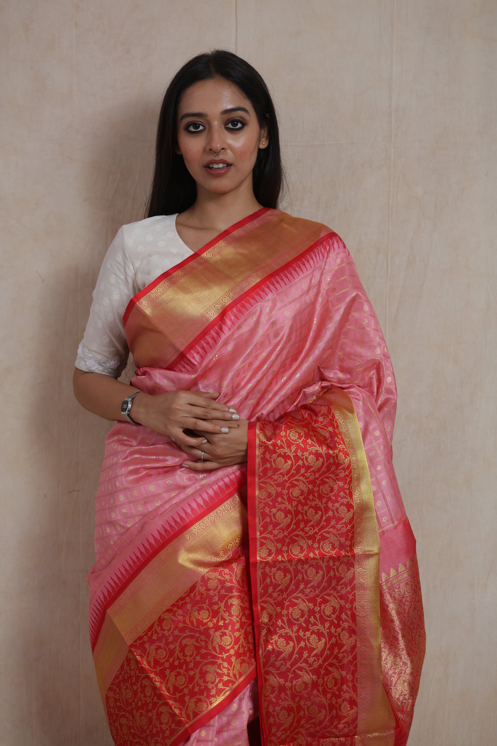 Close-up of the blush pink Venkatgiri silk saree displaying gold woven checks, elegant border, and richly woven floral pallu.