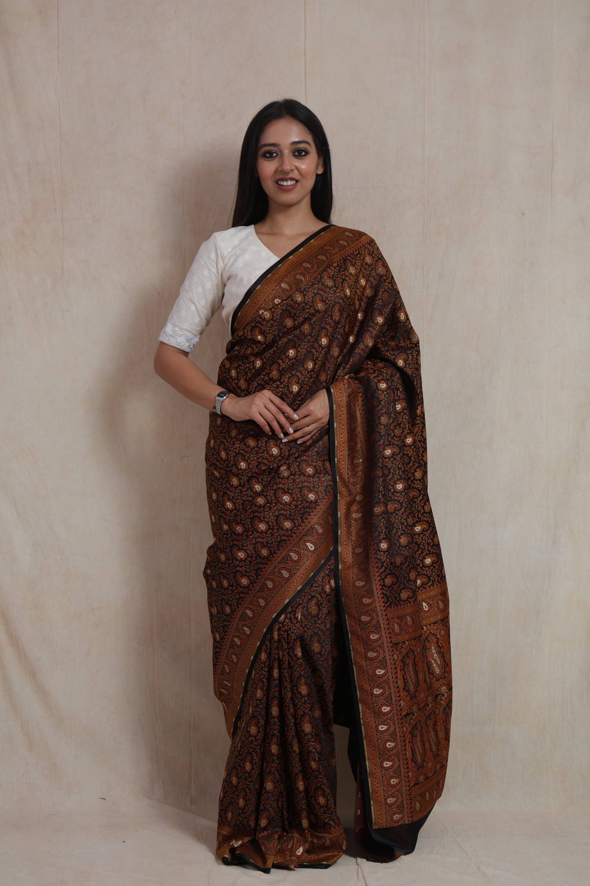 Model wearing classic black Banarasi silk saree with intricate paisley woven motifs