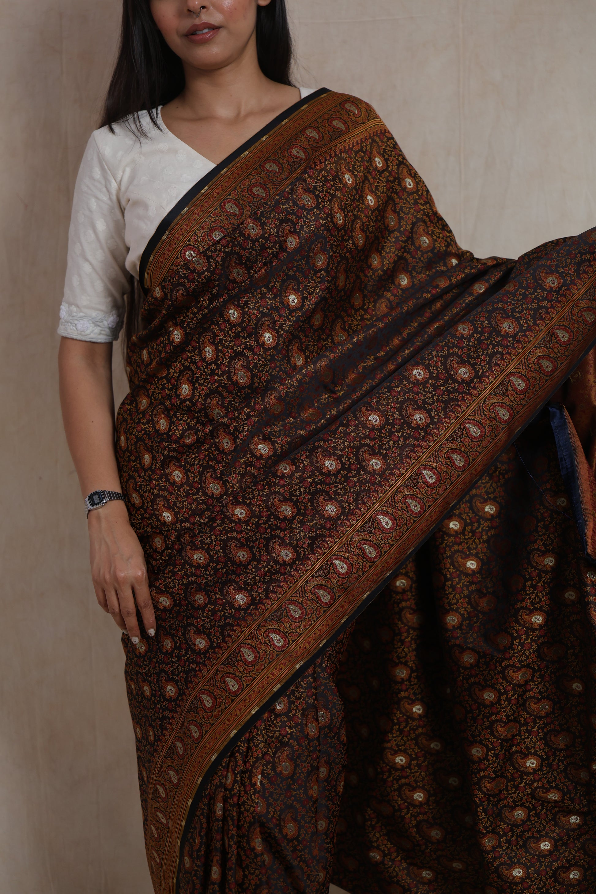 Close-up of black Banarasi silk saree with detailed paisley weave