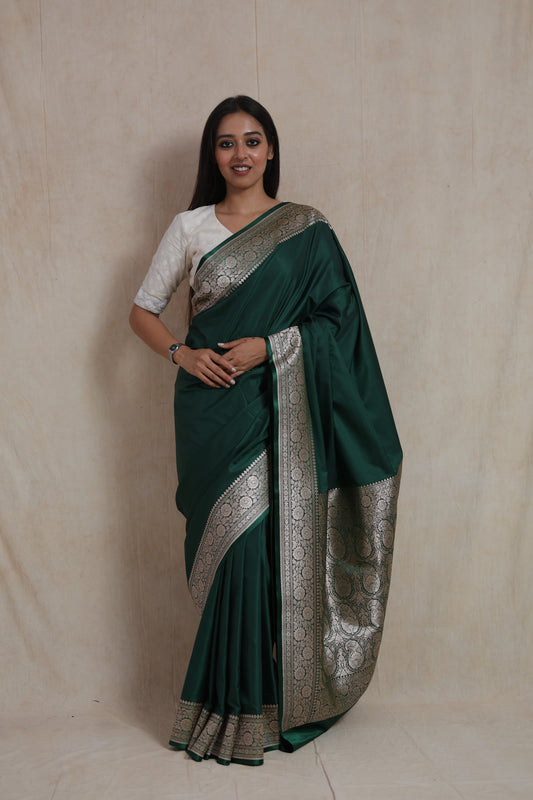 Model wearing emerald green Banarasi art silk saree front view