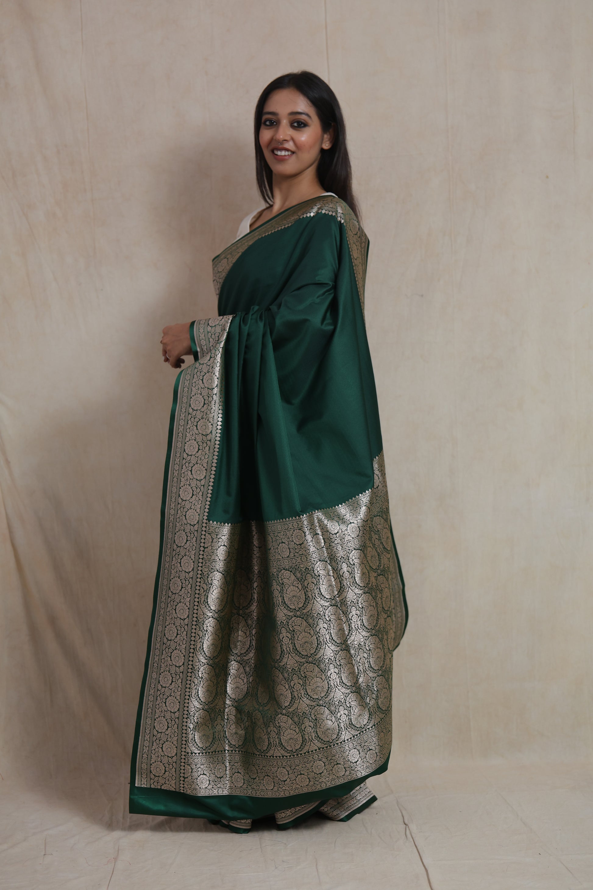 Side view of emerald green Banarasi art silk saree showcasing elegant drape
