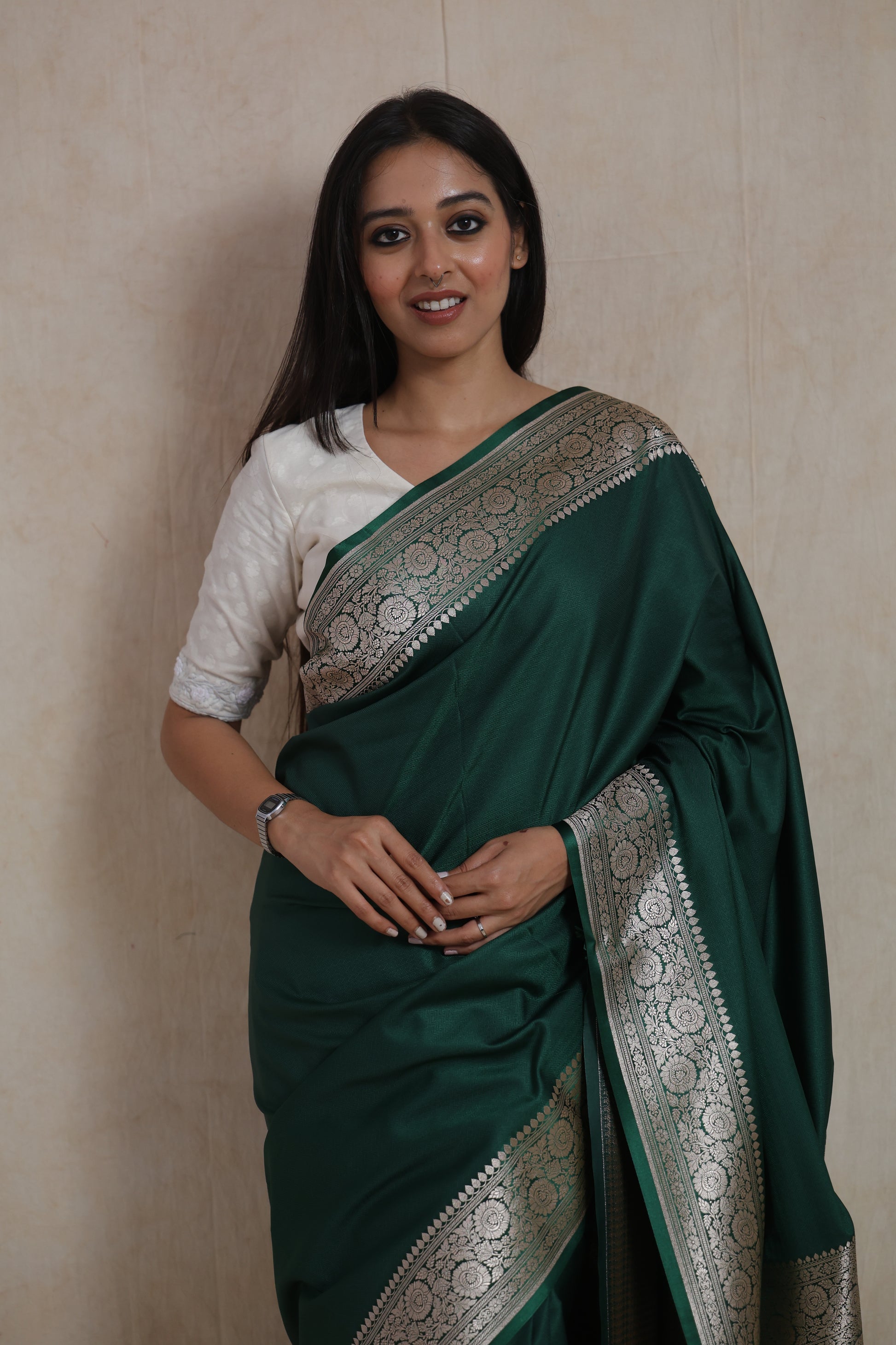 Close-up of emerald green Banarasi art silk saree highlighting woven floral border