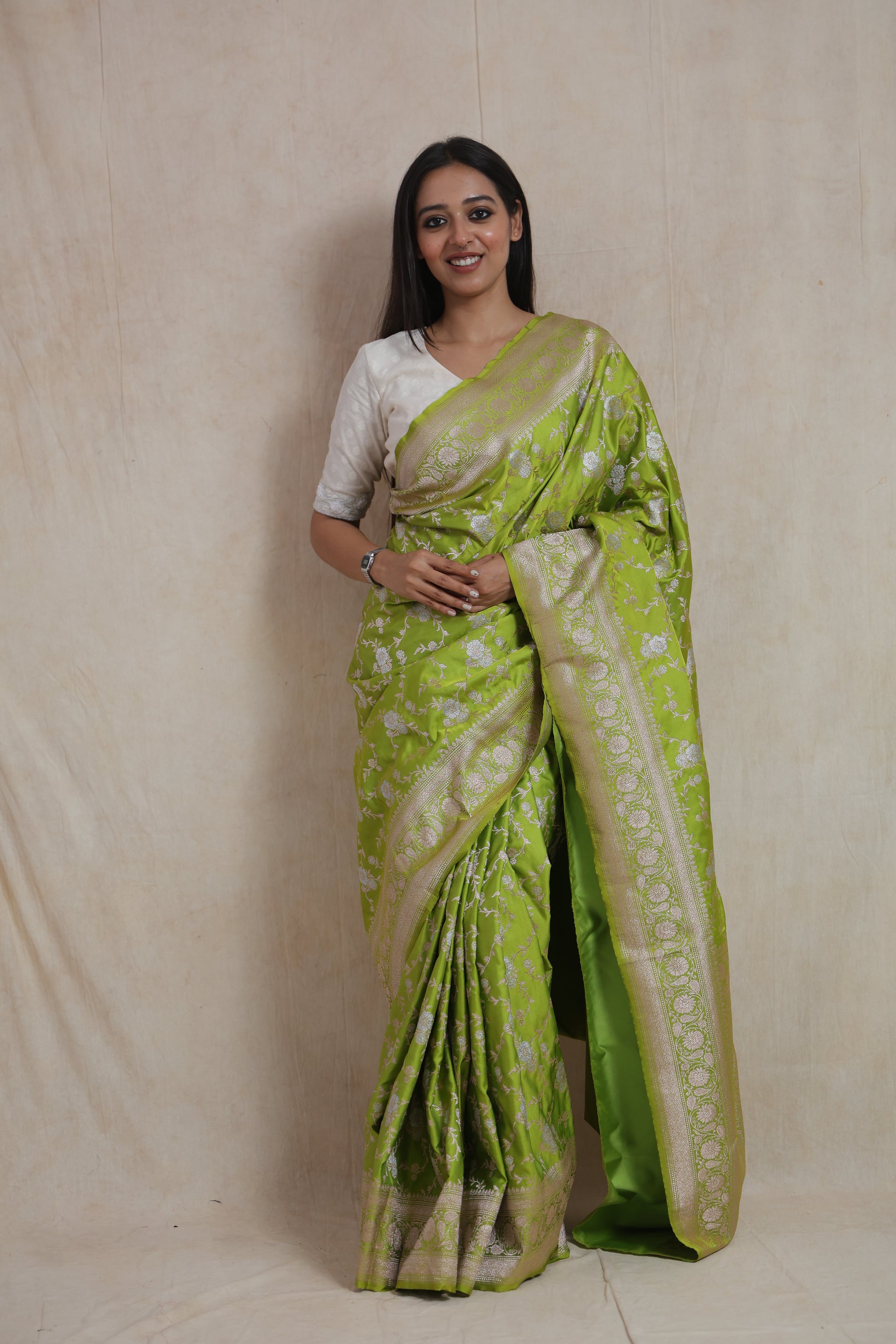 Full-length view of lime green Banarasi art silk saree with ornate woven border and pallu