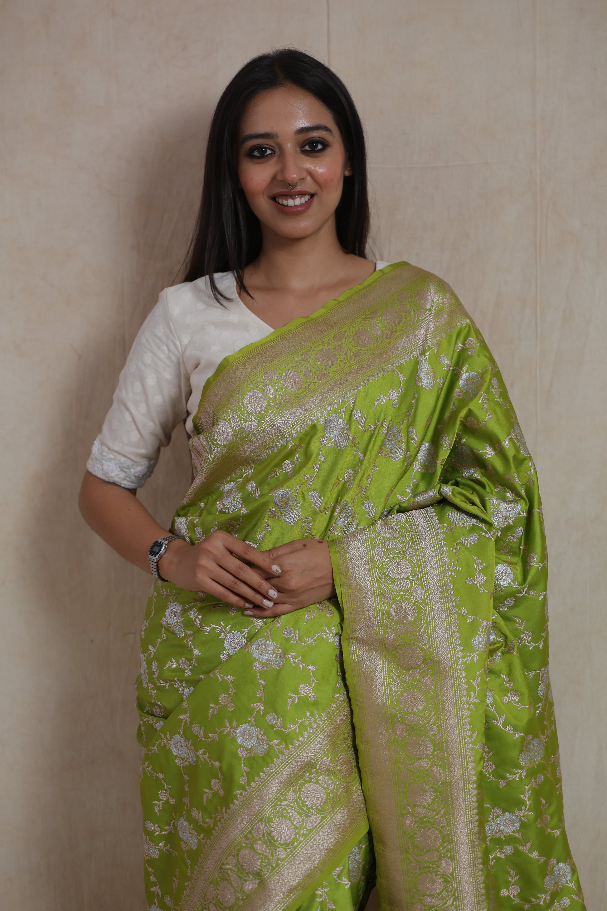 Close-up of lime green Banarasi art silk saree featuring intricate floral woven detailing