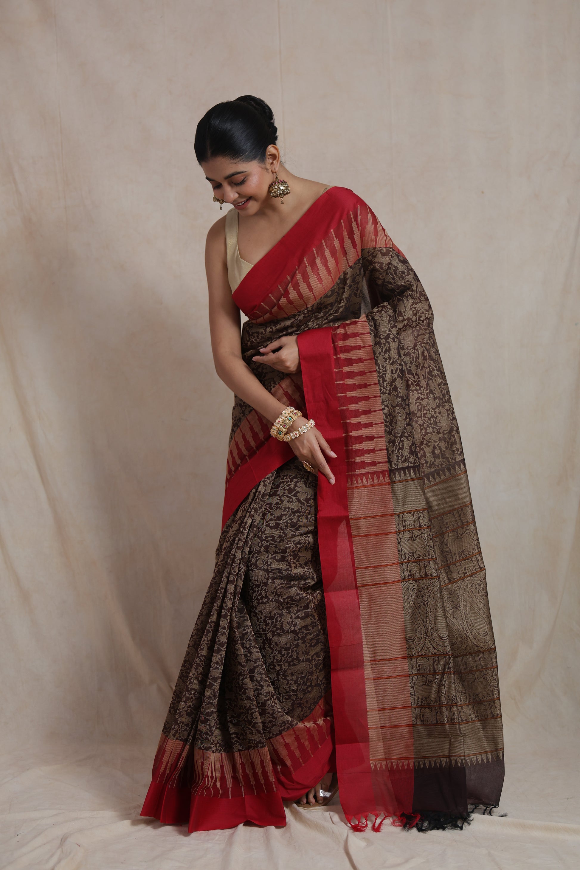 Graceful drape of handloom Kanchipuram cotton saree in black and crimson red