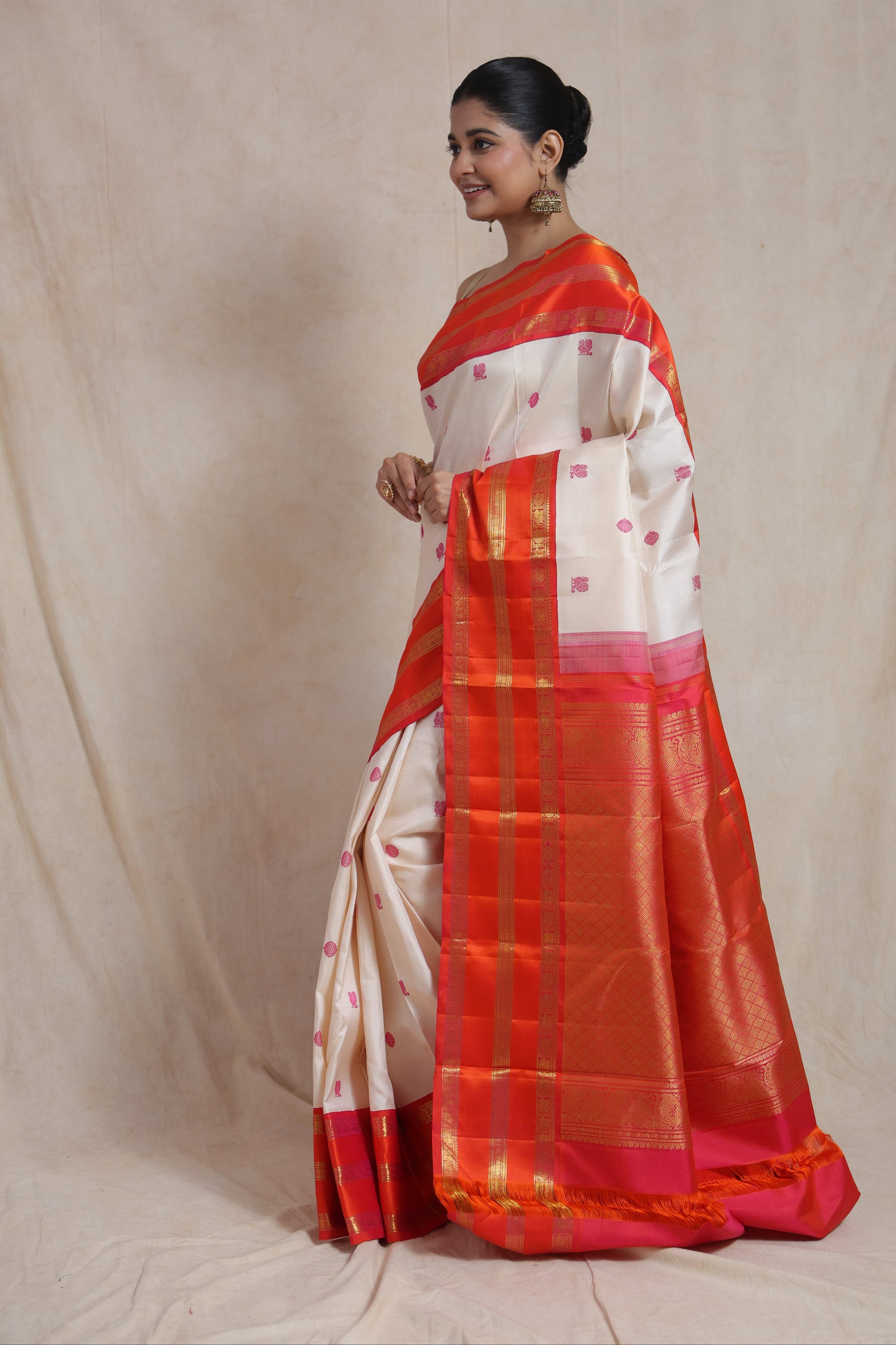 Side profile of Kanjivaram pure silk saree with coral orange border and traditional woven detailing