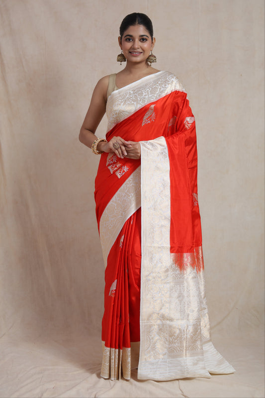 Front view of royal vermilion red Banarasi silk saree with bird motifs and floral woven border
