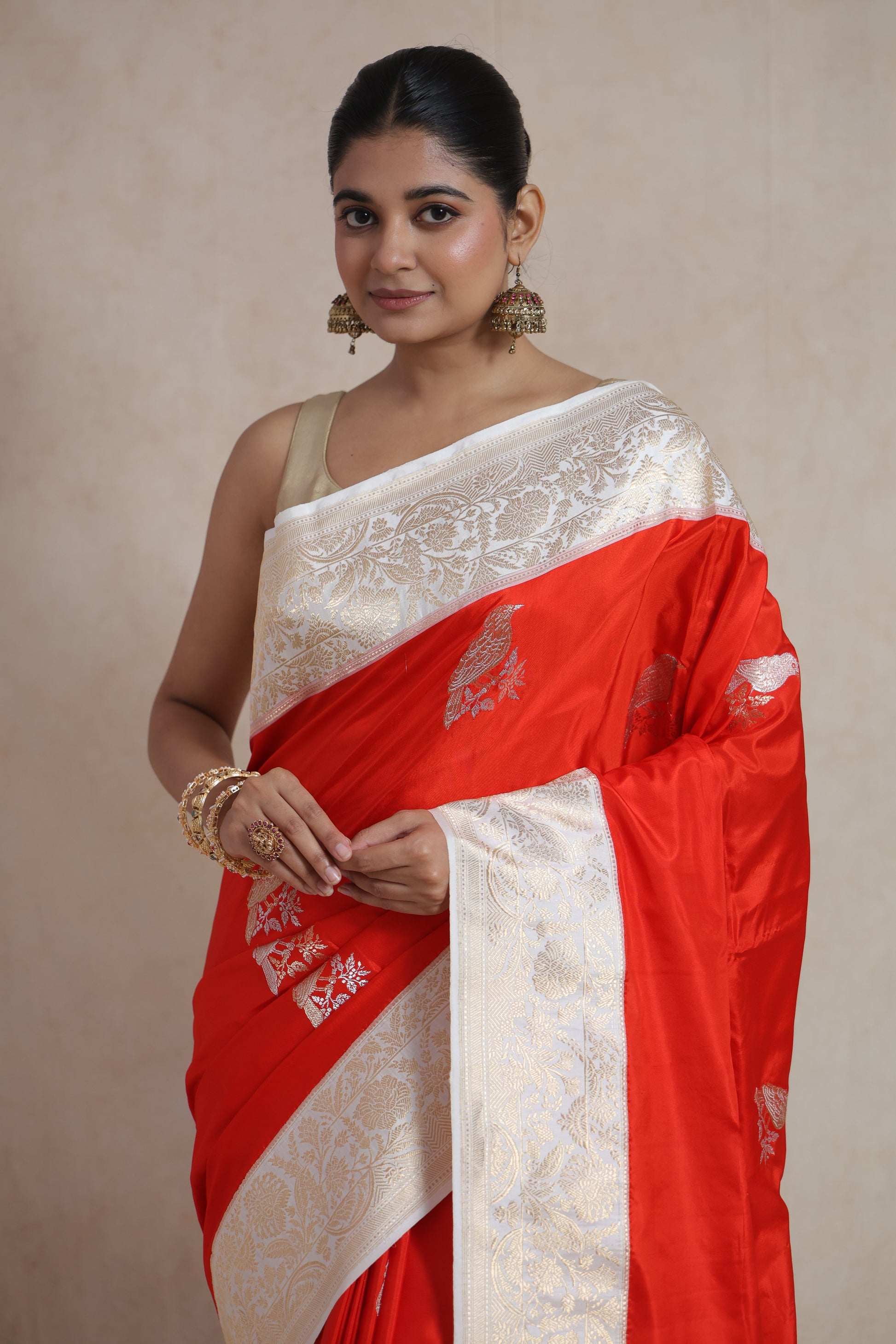 Close-up of Banarasi silk saree featuring intricate bird motifs and detailed floral border