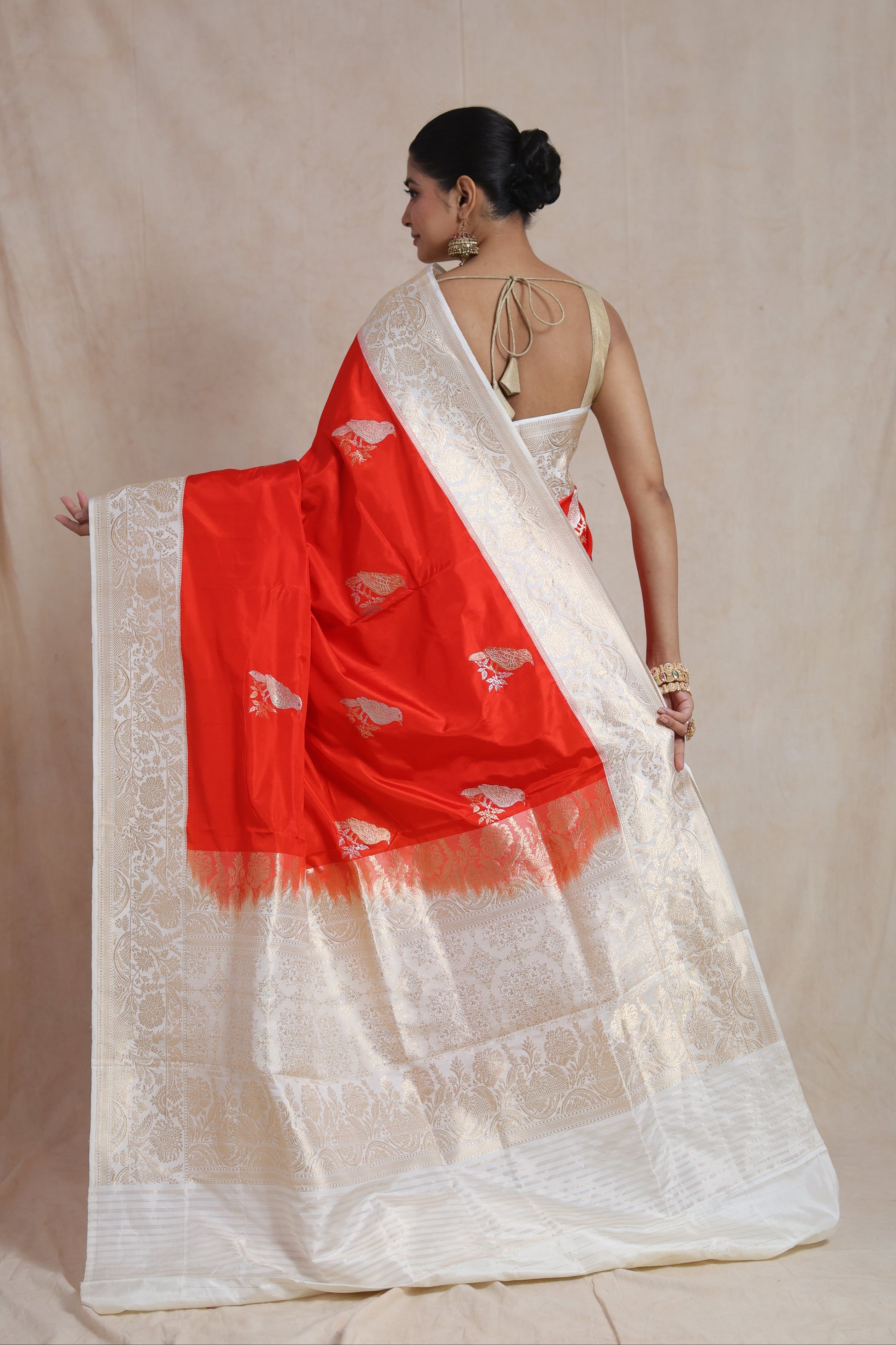 Back view showcasing the richly woven pallu and floral border of a Banarasi silk saree