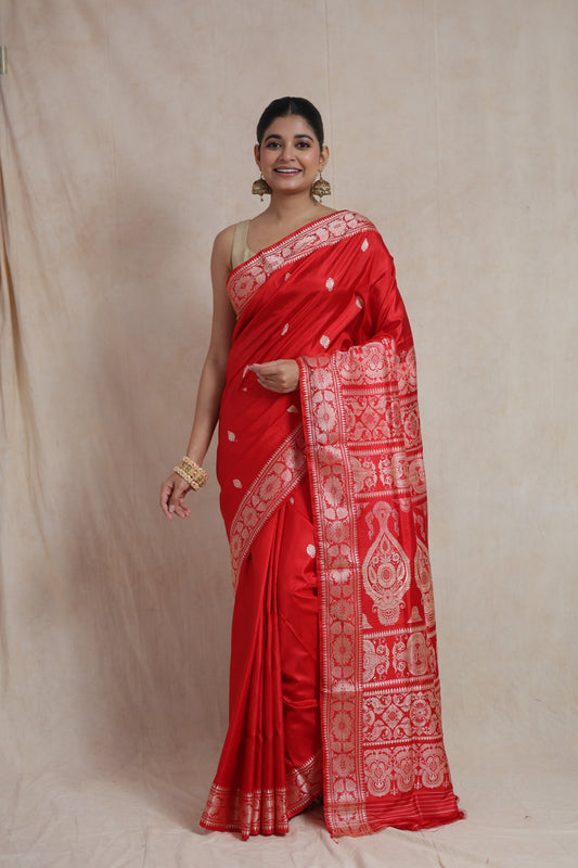 Front view of a royal red Banarasi silk saree featuring delicate woven buttas, an elegant floral border, and a richly woven traditional pallu.