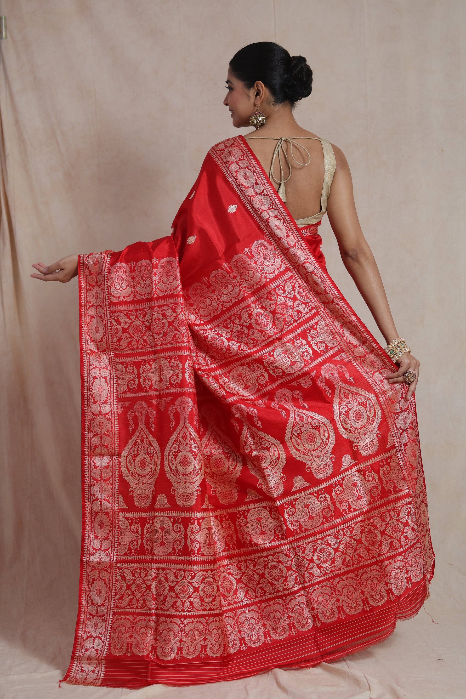 Back view of the royal red Banarasi silk saree showcasing its grand woven pallu with intricate traditional motifs.