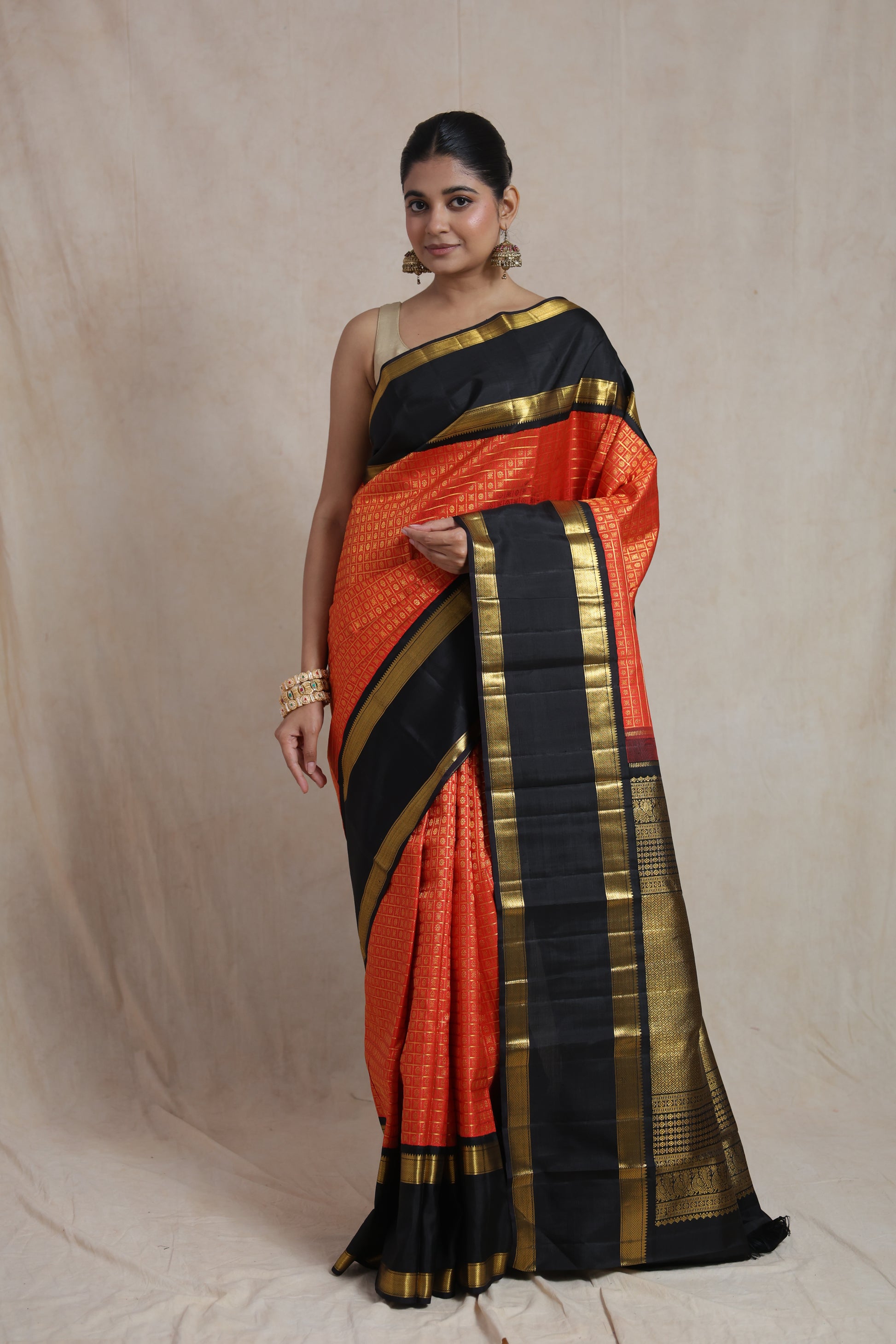 Vermilion red and black Kanjivaram pure silk saree with traditional woven motifs and contrast border