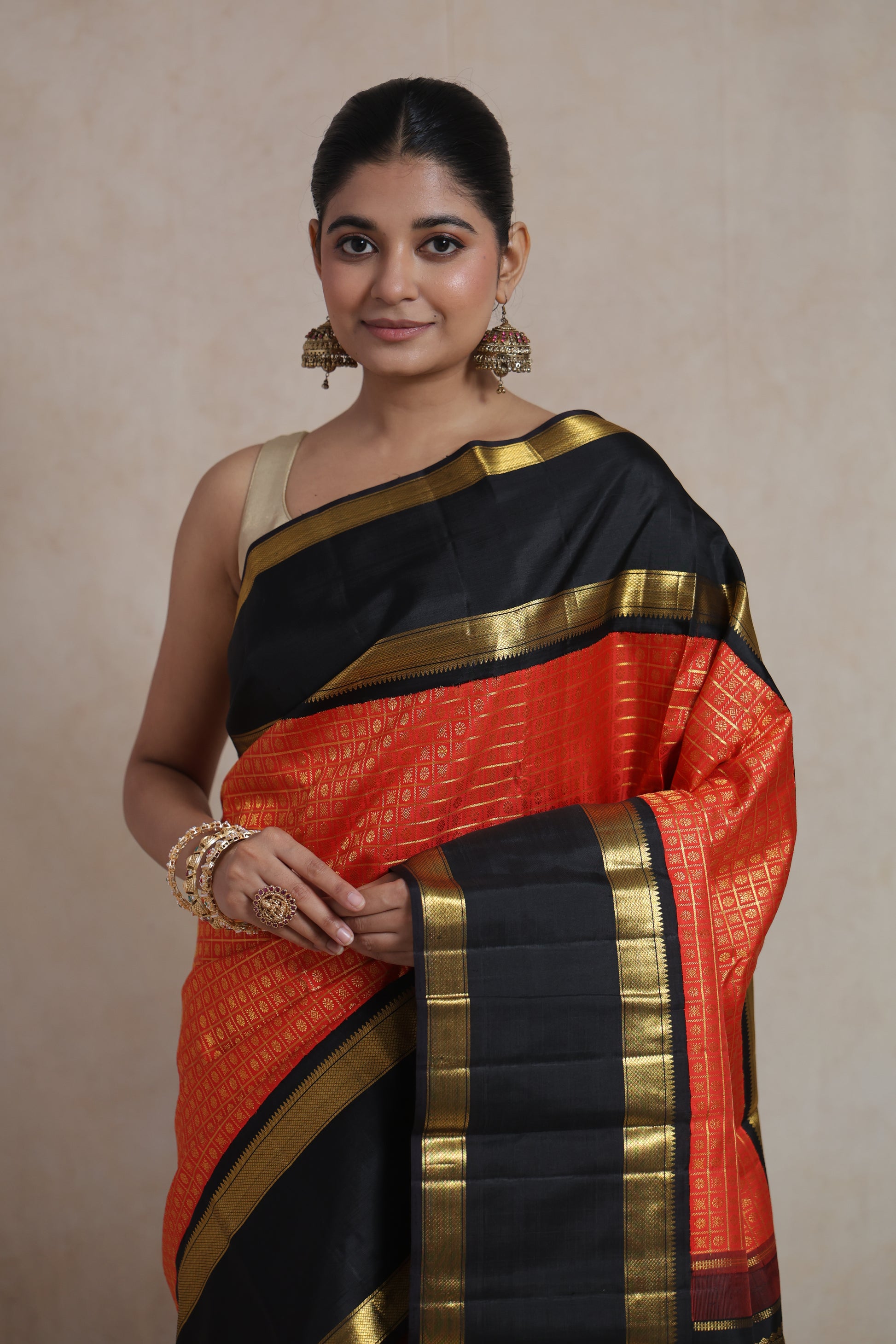 Close-up of vermilion red Kanjivaram pure silk saree showcasing intricate woven patterns