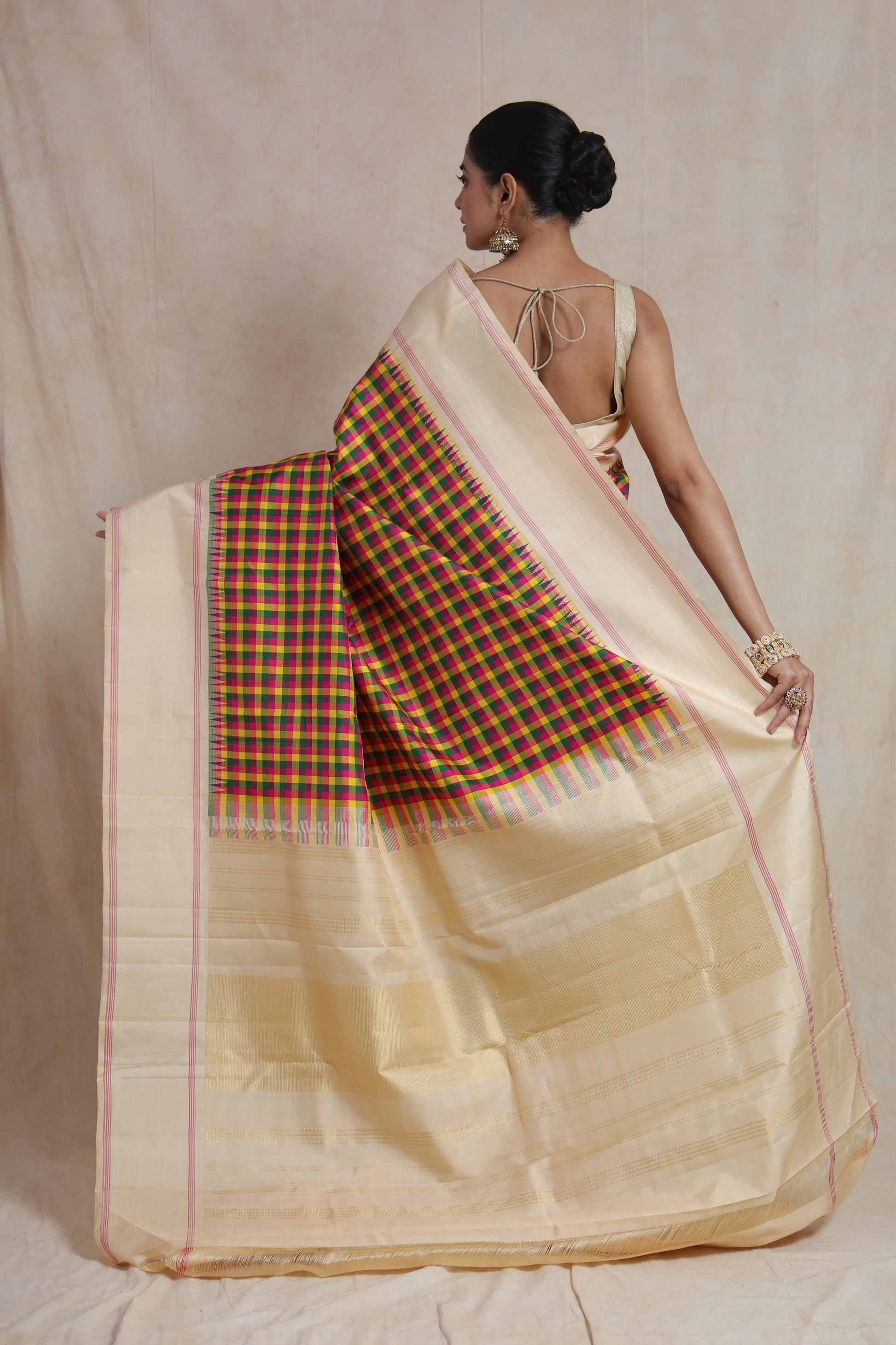 Back view of ivory Kanjivaram silk saree highlighting vibrant checked pallu and traditional craftsmanship