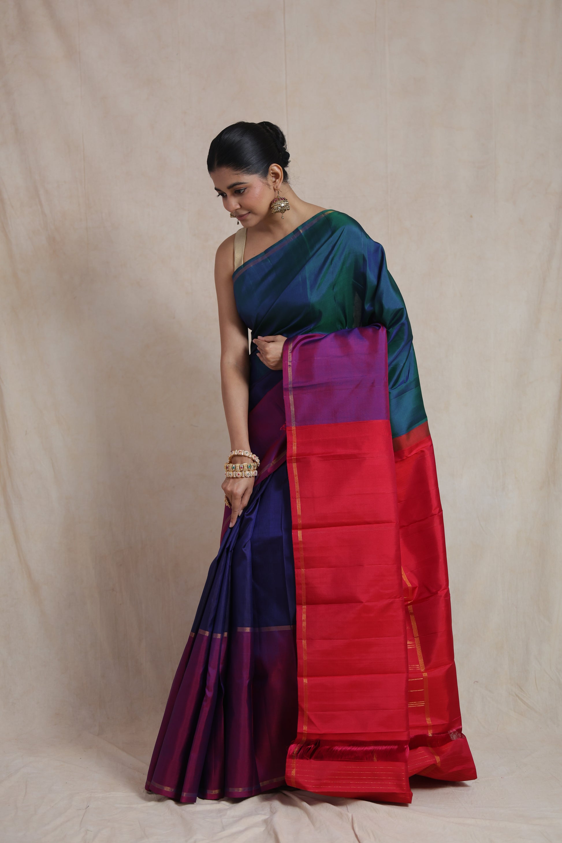 Elegant drape of peacock blue Kanjivaram pure silk saree with contrasting pink border