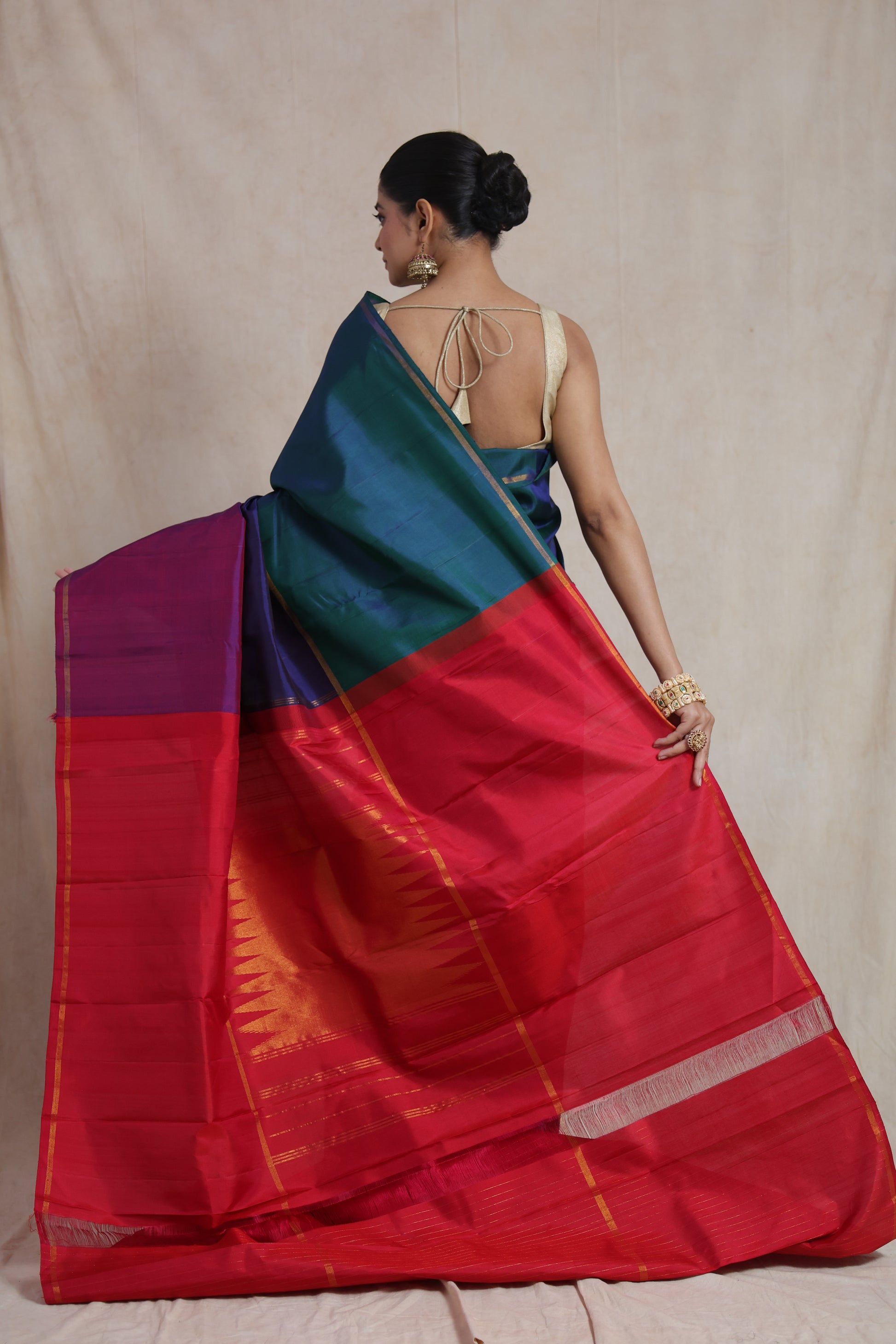 Back view showcasing the rich rani pink pallu of a peacock blue Kanjivaram pure silk saree
