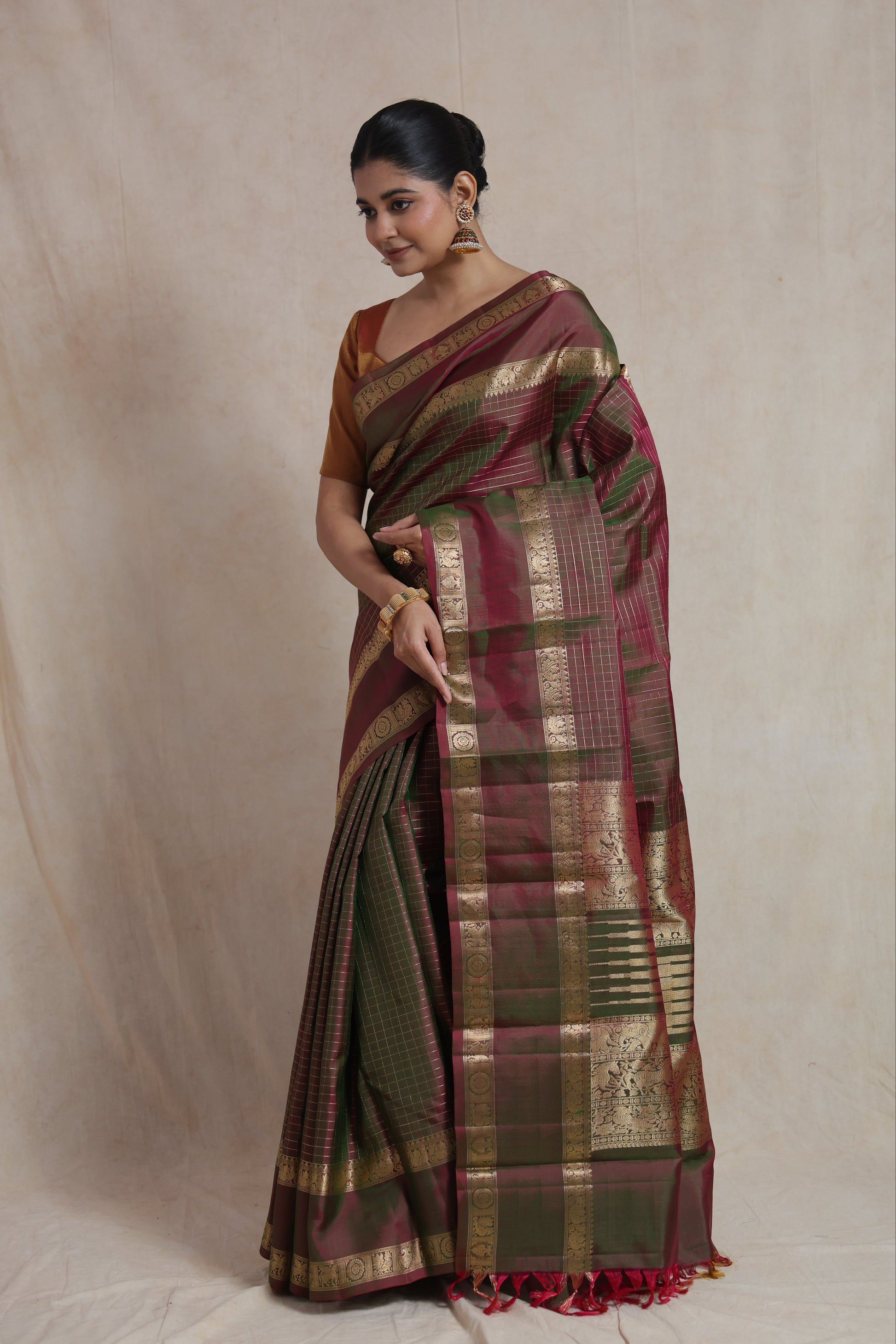 Side drape view of dual-tone olive green and wine Kanjivaram pure silk saree featuring heritage woven pallu