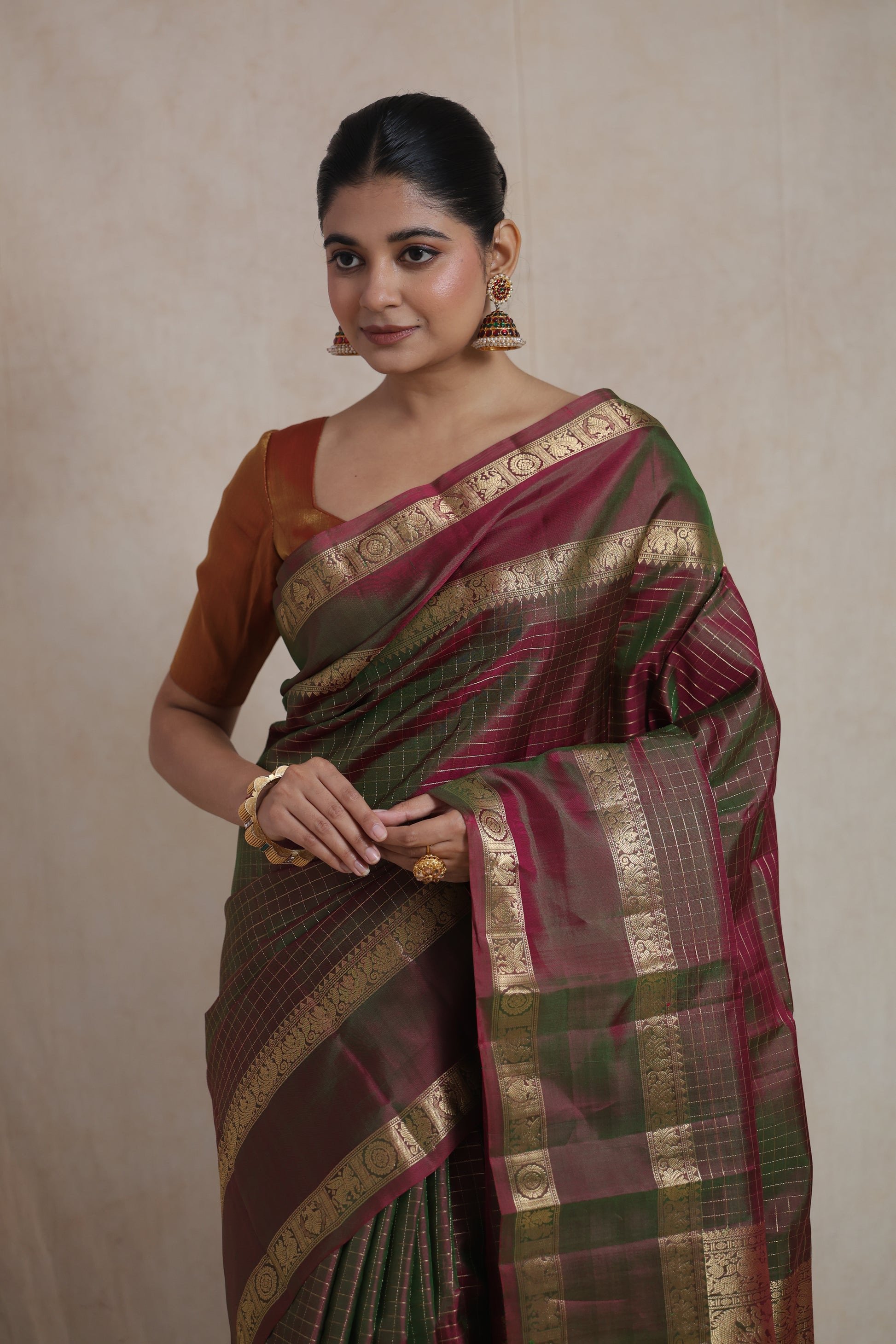 Close-up of olive green and wine Kanjivaram pure silk saree with intricate checks weaving and traditional motifs