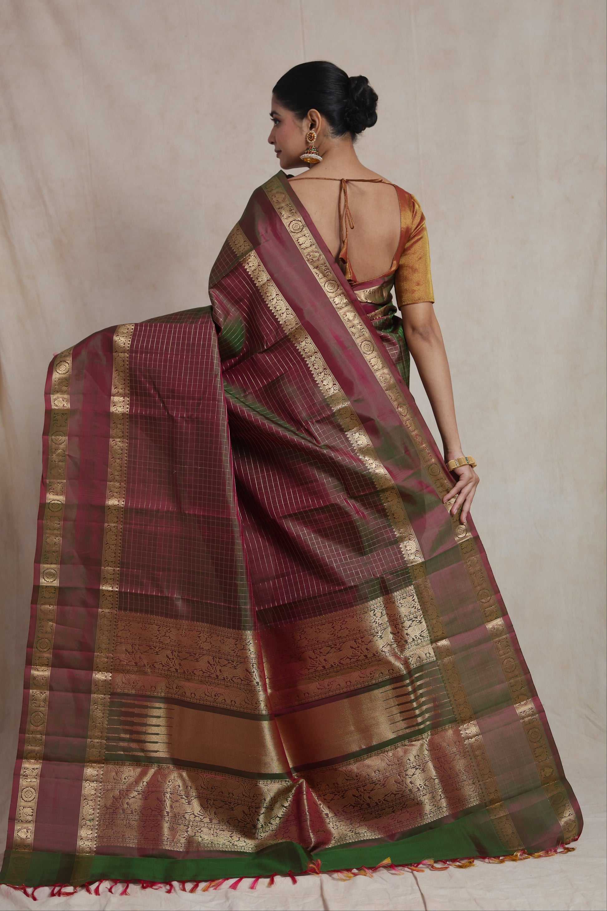 Back view of dual-tone olive green and wine Kanjivaram pure silk saree showcasing grand woven pallu and border