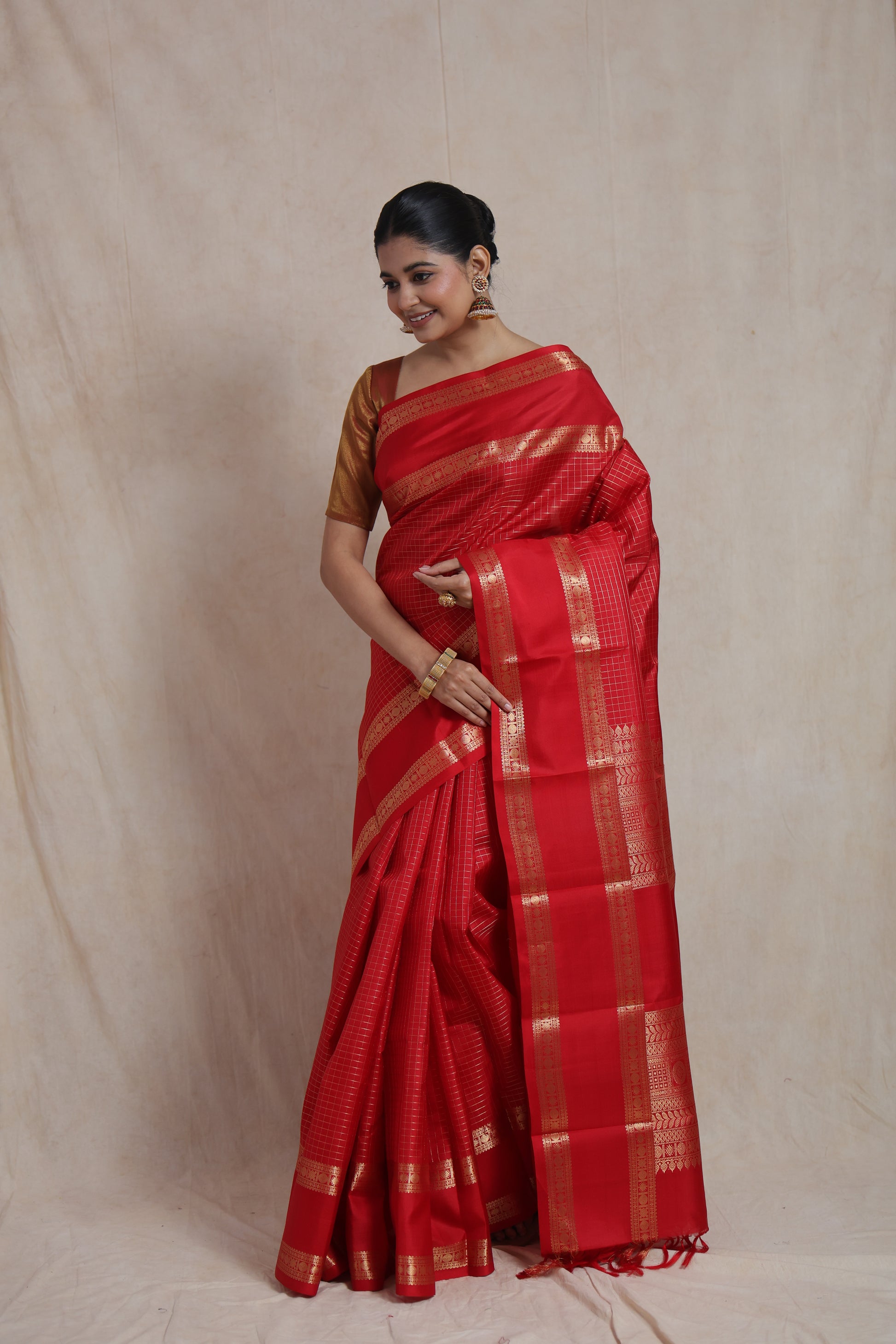 Graceful drape of crimson red Kanjivaram pure silk saree showcasing classic craftsmanship and luxurious texture