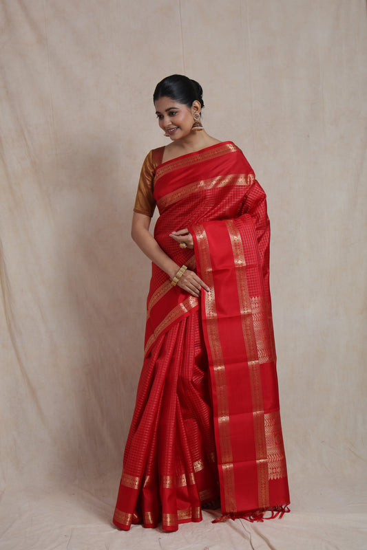 Graceful drape of crimson red Kanjivaram pure silk saree showcasing classic craftsmanship and luxurious texture
