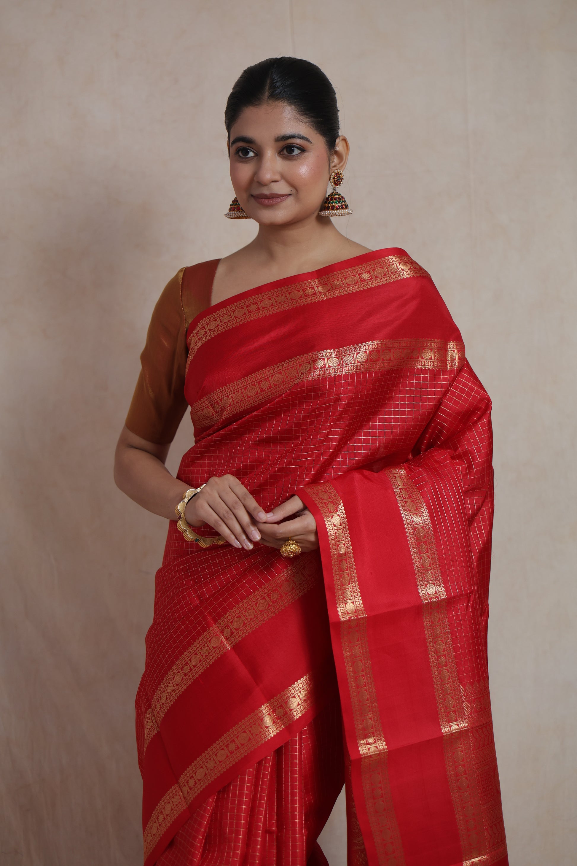 Detailed view of crimson red Kanjivaram pure silk saree with traditional woven motifs and ornate border