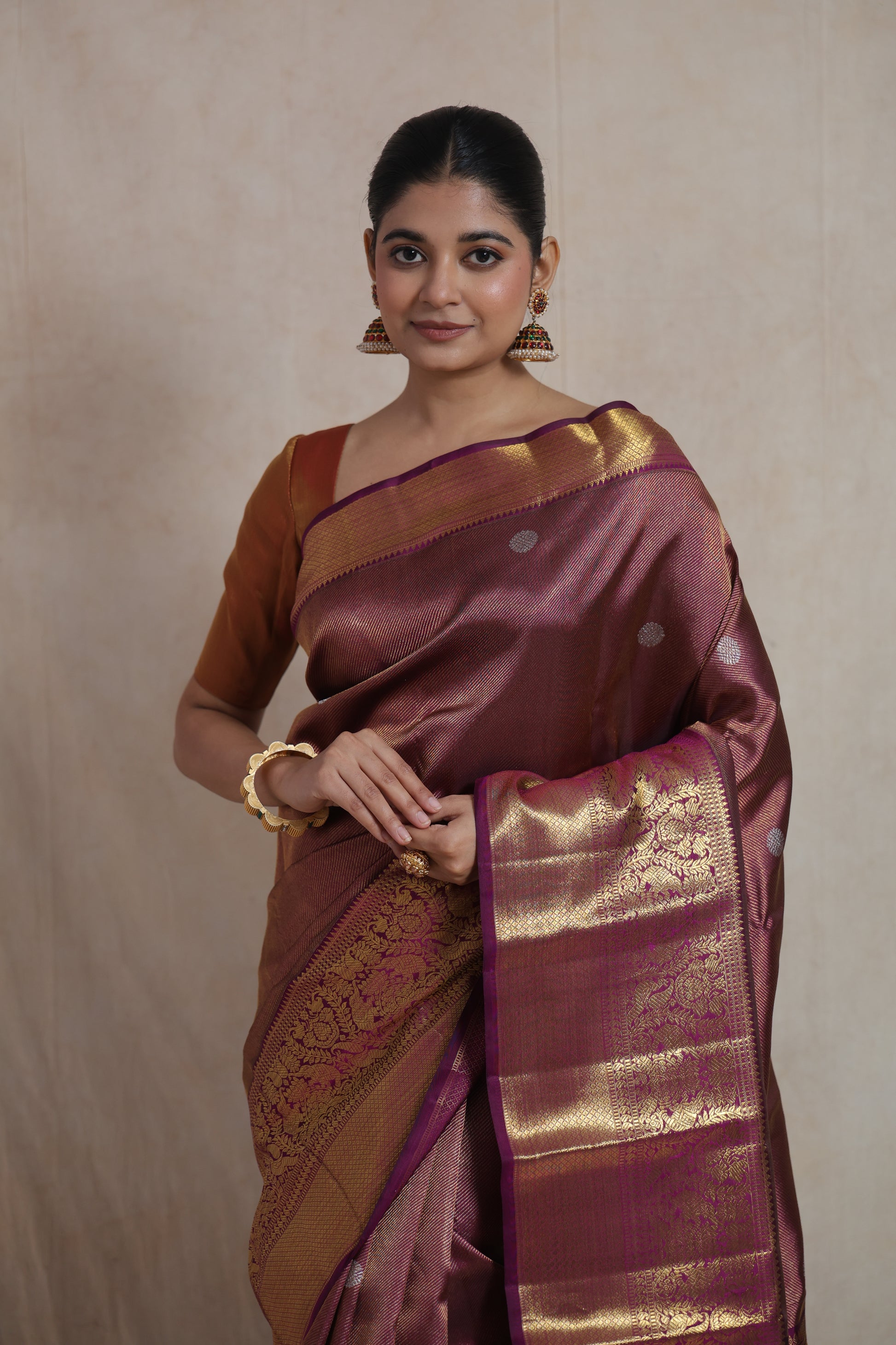 Close-up of antique gold woven border and silver buttas on mauve Kanjivaram pure silk saree