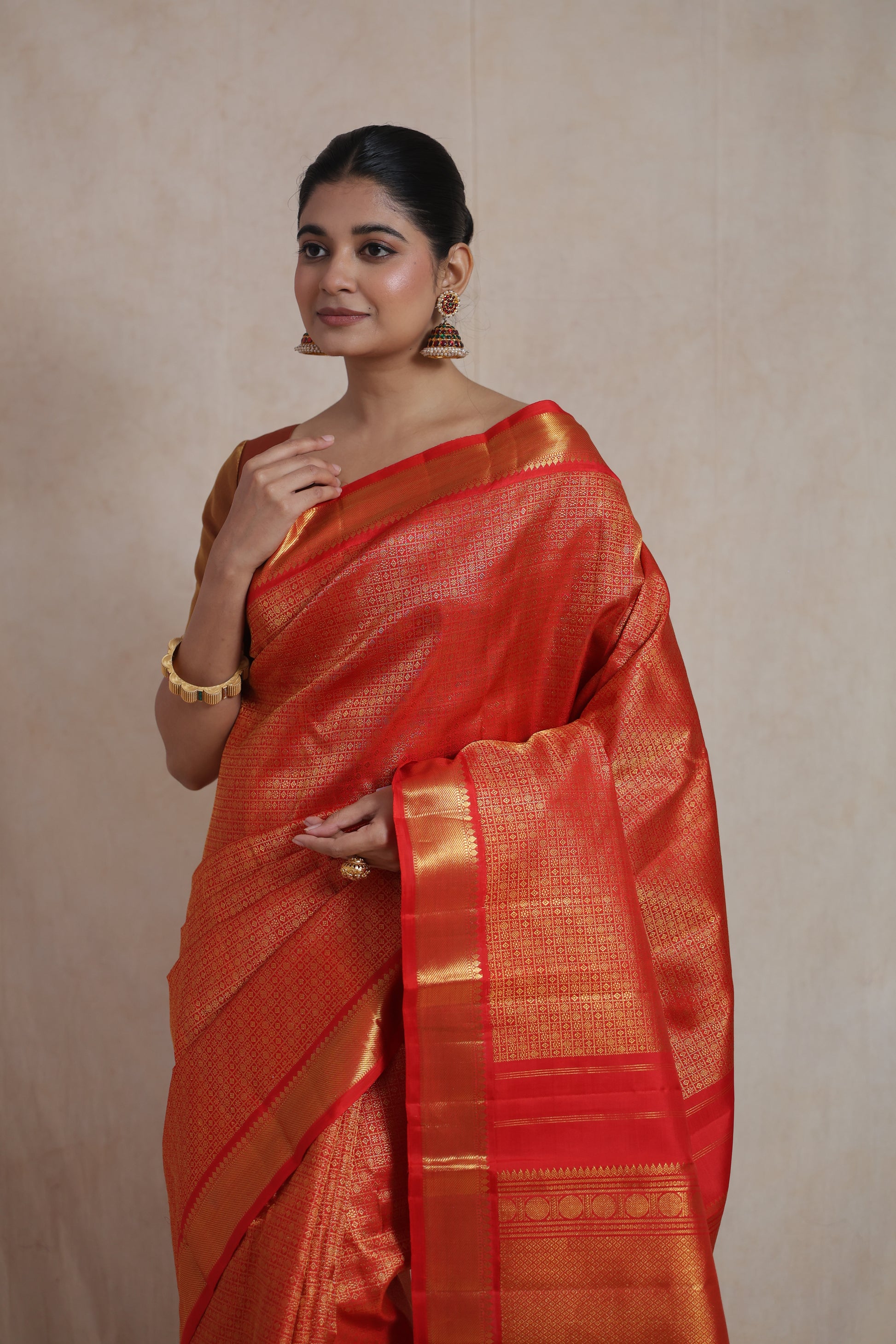 Elegant vermilion red Kanjivaram pure silk saree with rich texture and classic craftsmanship