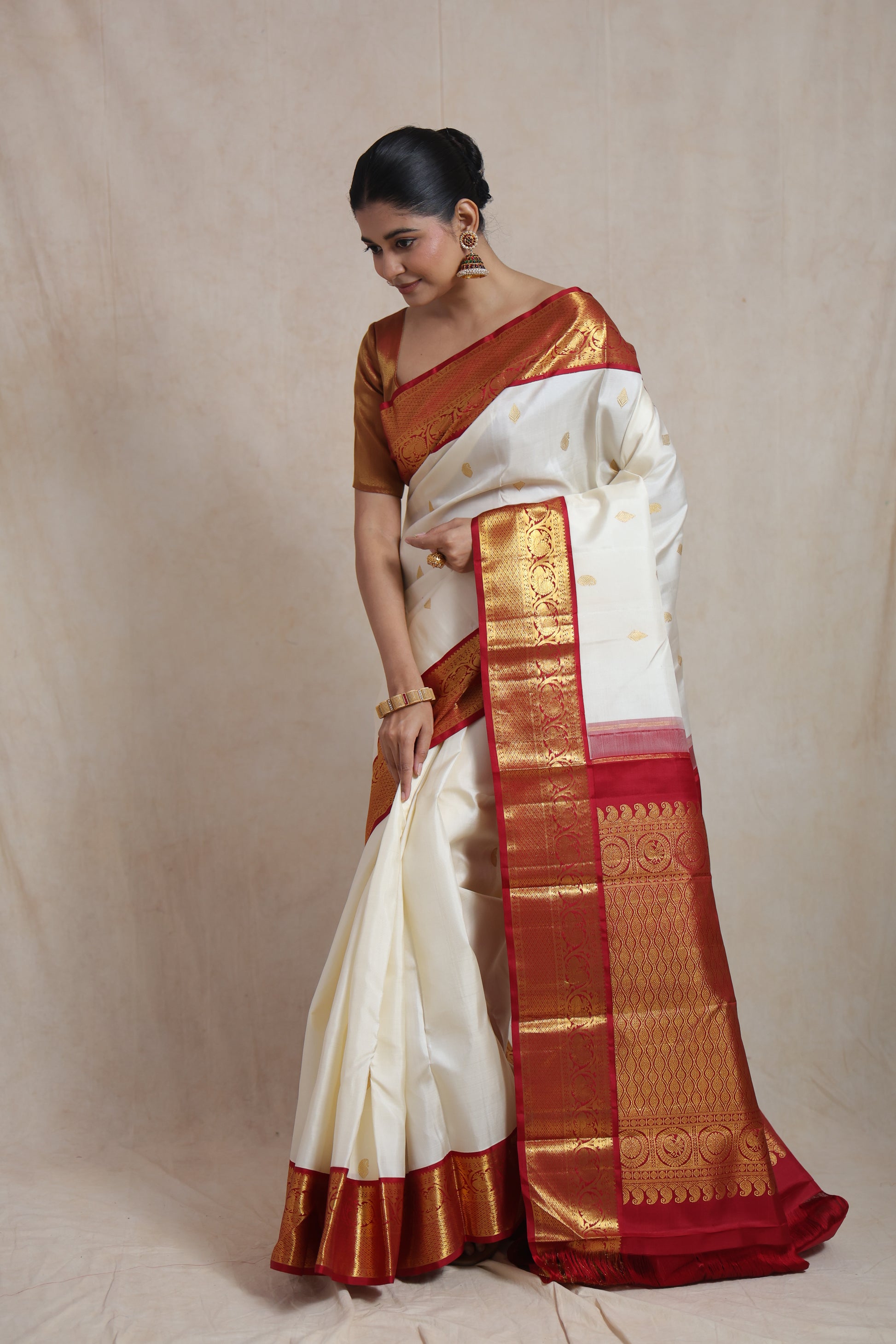 Elegant ivory and red Kanjivaram pure silk saree draped for festive and bridal occasions