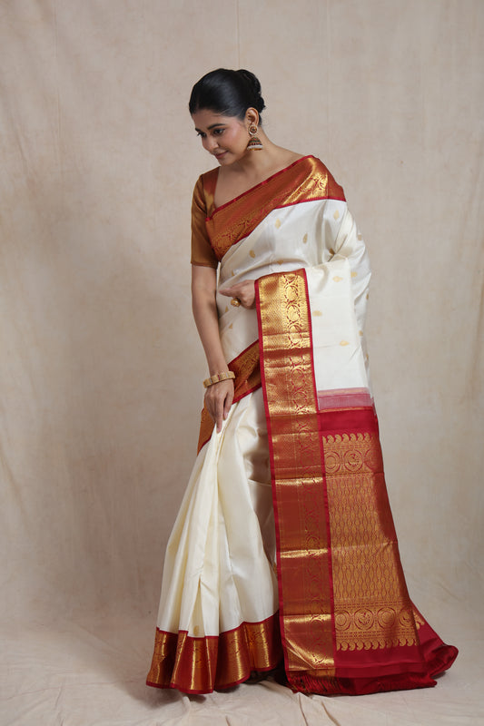 Elegant ivory and red Kanjivaram pure silk saree draped for festive and bridal occasions