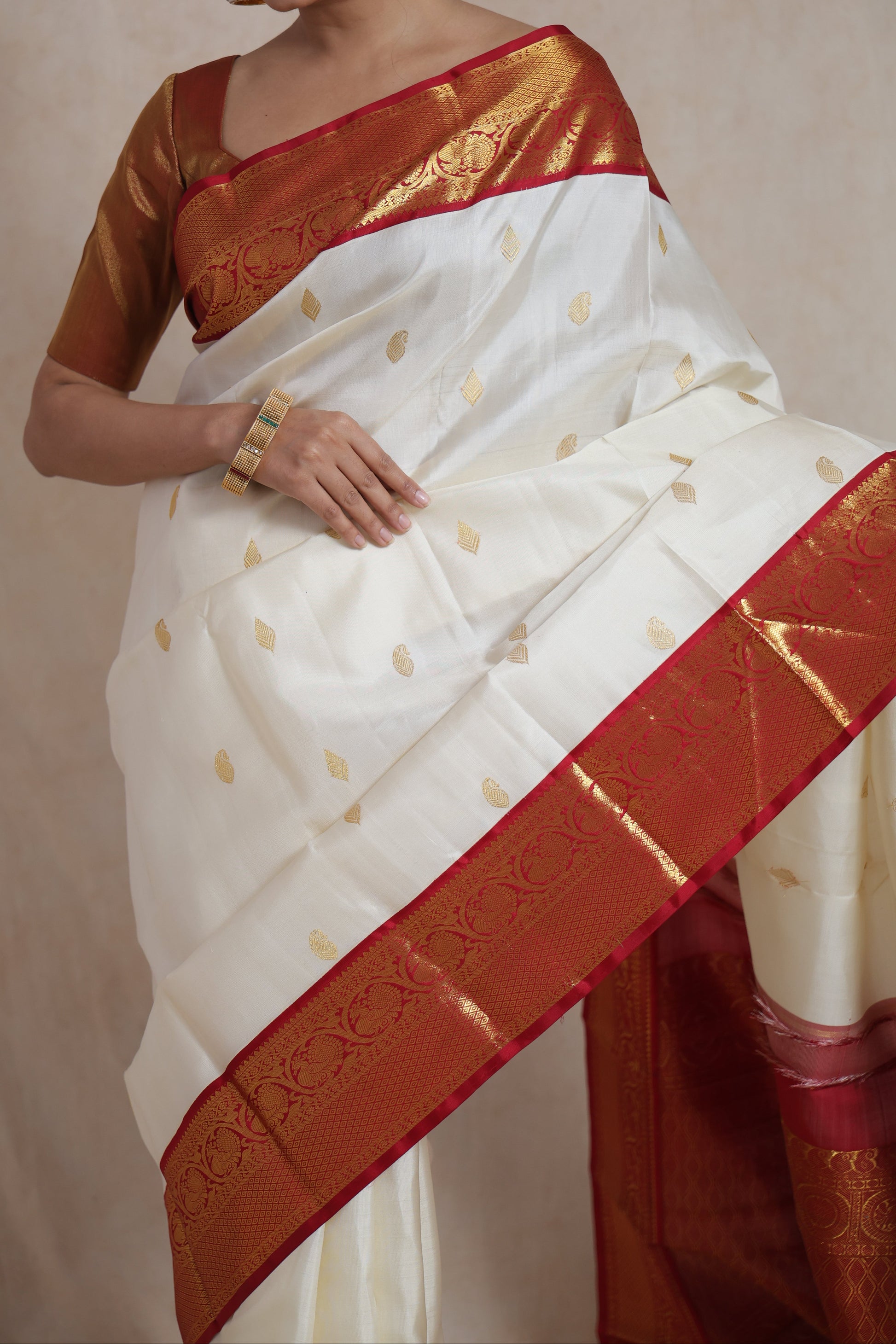 Detailed view of richly woven red pallu on ivory white Kanjivaram pure silk saree
