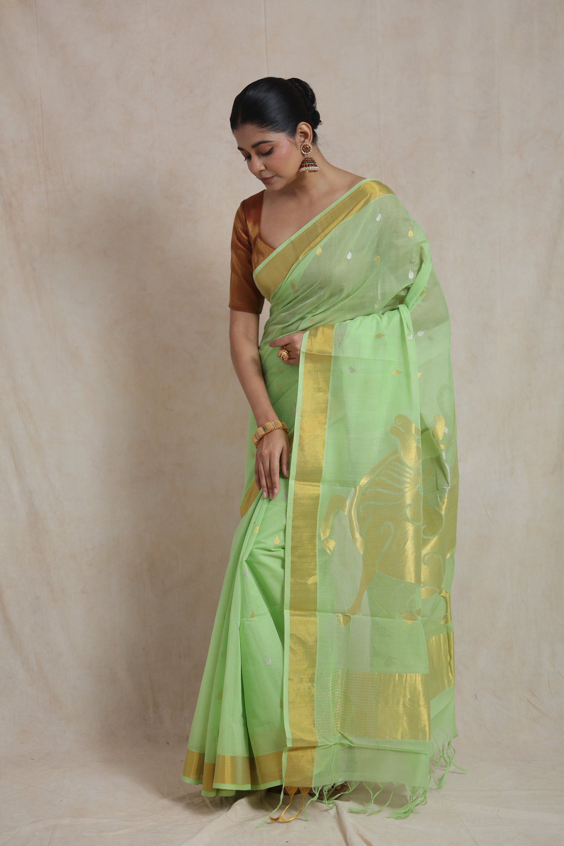 Elegant drape view of mint green Kanchipuram cotton saree with woven motifs